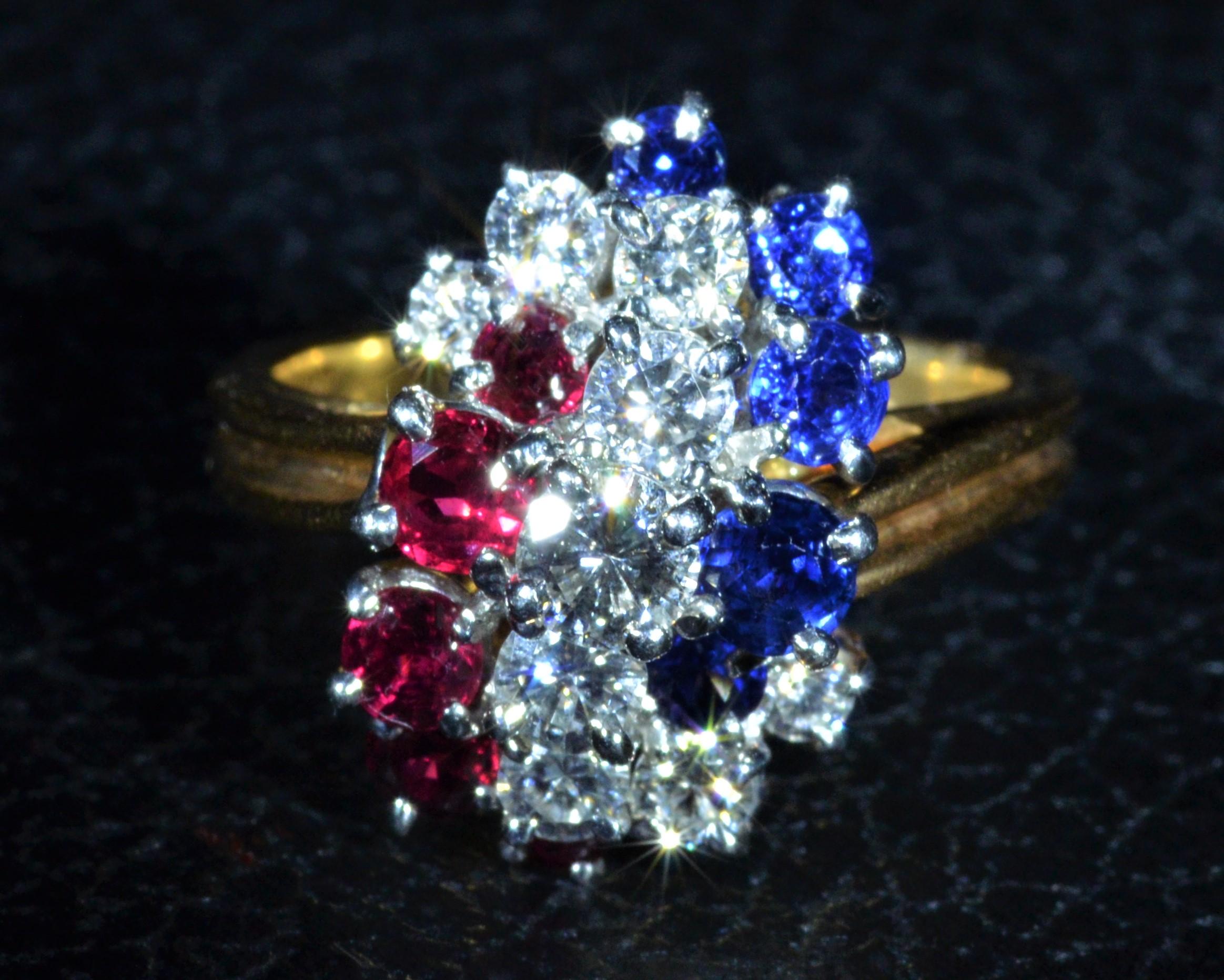 Vintage Signed Oscar Heyman Patriotic Ring featuring Rubies, diamonds, and sapphires.  The ring is made in 18 karat yellow gold and has platinum boxes hold in each stone.  There are approximately 0.75 carats in Natural very slightly purplish-Red