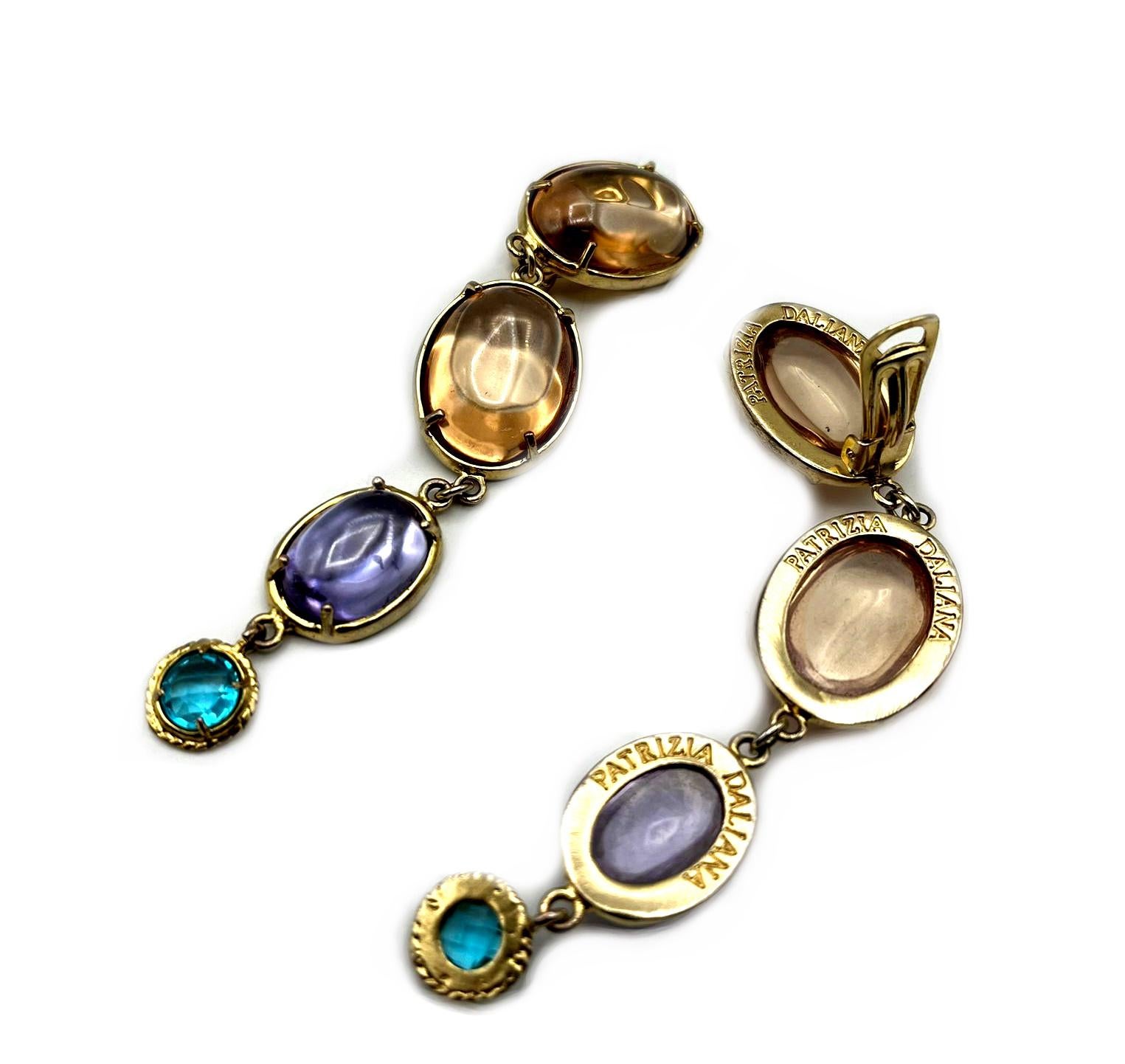 Long Patrizia Daliana earrings in 24 KT gilded bronze with glass crystals. A silver clip is used to wear it on the ear. To fix the stones to our jewels, according to the Italian goldsmith tradition, we use the claw setting technique, thus giving the