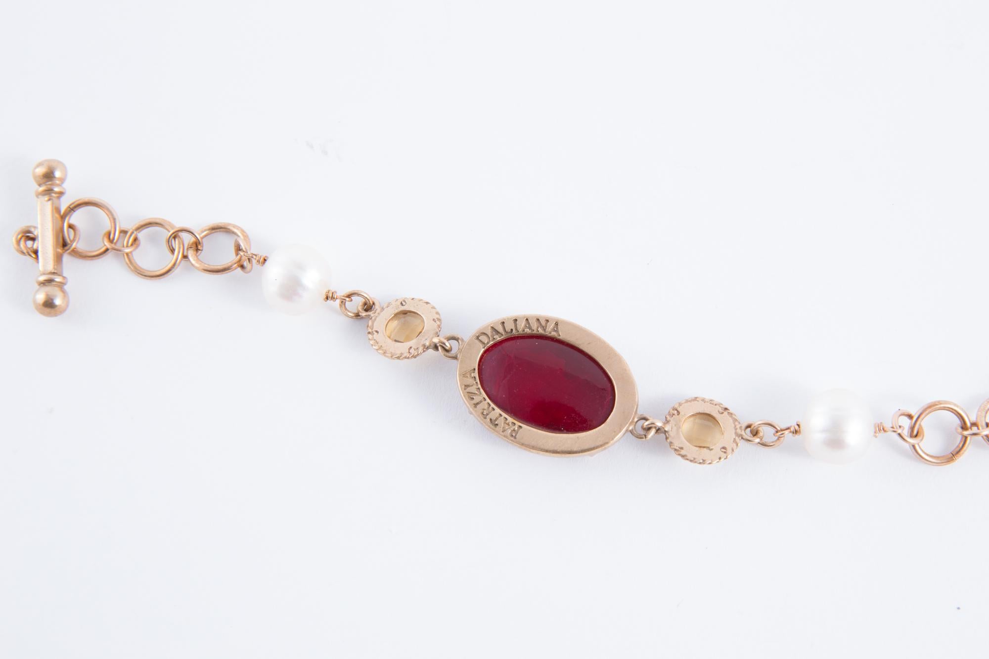 Patrizia Daliana bracelet featuring engraved dark red Murano glass with cameo, faux pearls and gold tone chain. 
8.2in (21cm) X 0.8in (2cm)
In excellent vintage condition. Made in Italy.
We guarantee you will receive this gorgeous item as described