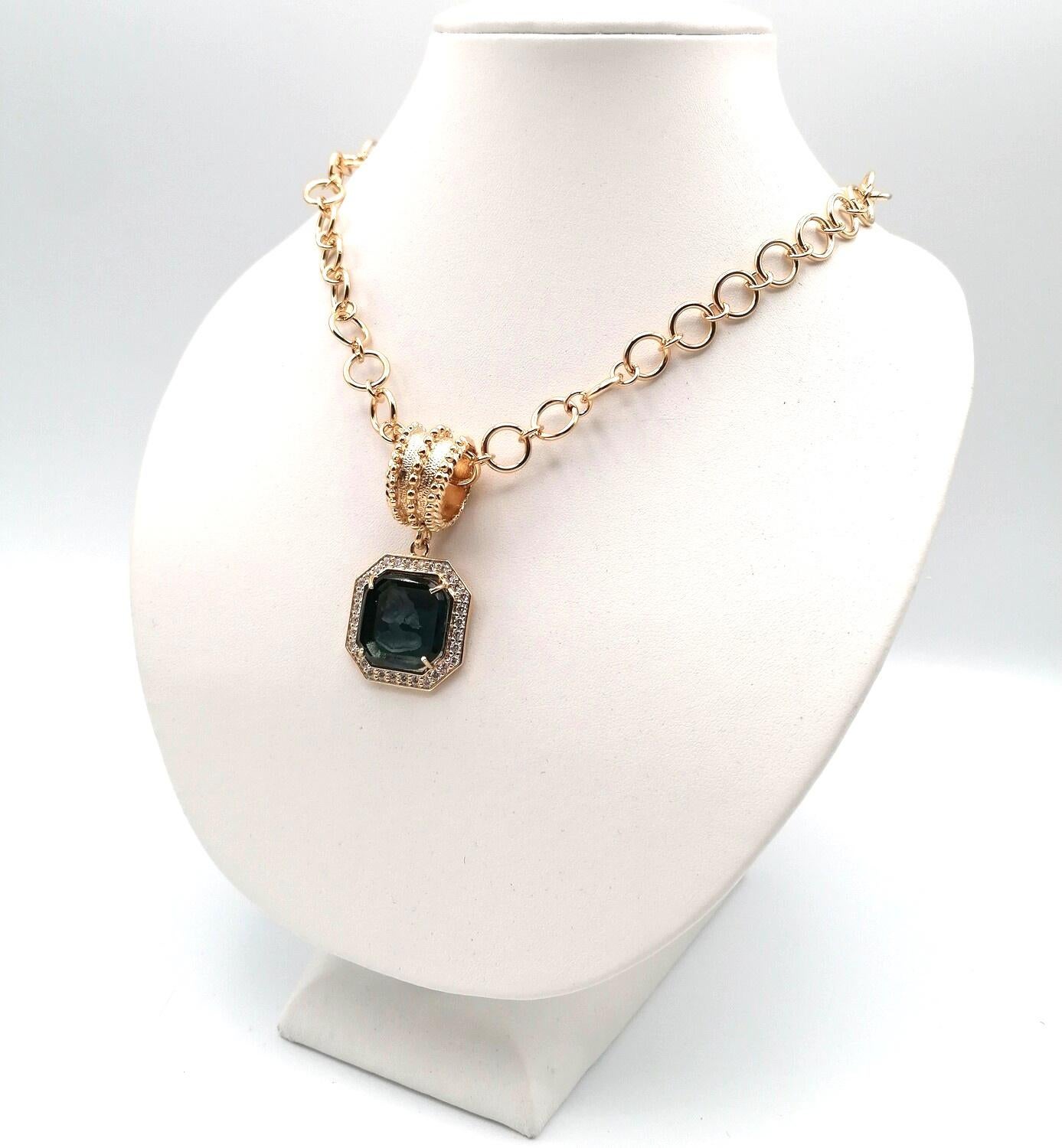 Patrizia Daliana, Pendant in 24 kt gilded bronze and zircons set in the frame, with hand-carved and ground Murano glass depicting an ancient Roman woman's head. The micro-cast loop adapts to all models of our chains. To fix the stones to our jewels,
