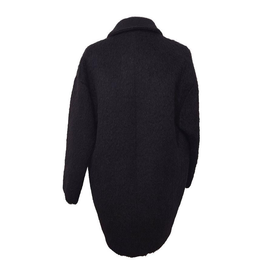 Wool, mohair. alpaca, polyester, nylo, cotton Black color Three buttons closure Two pockets Shoulder/hem cm 70 (27,5 inches) Over fit