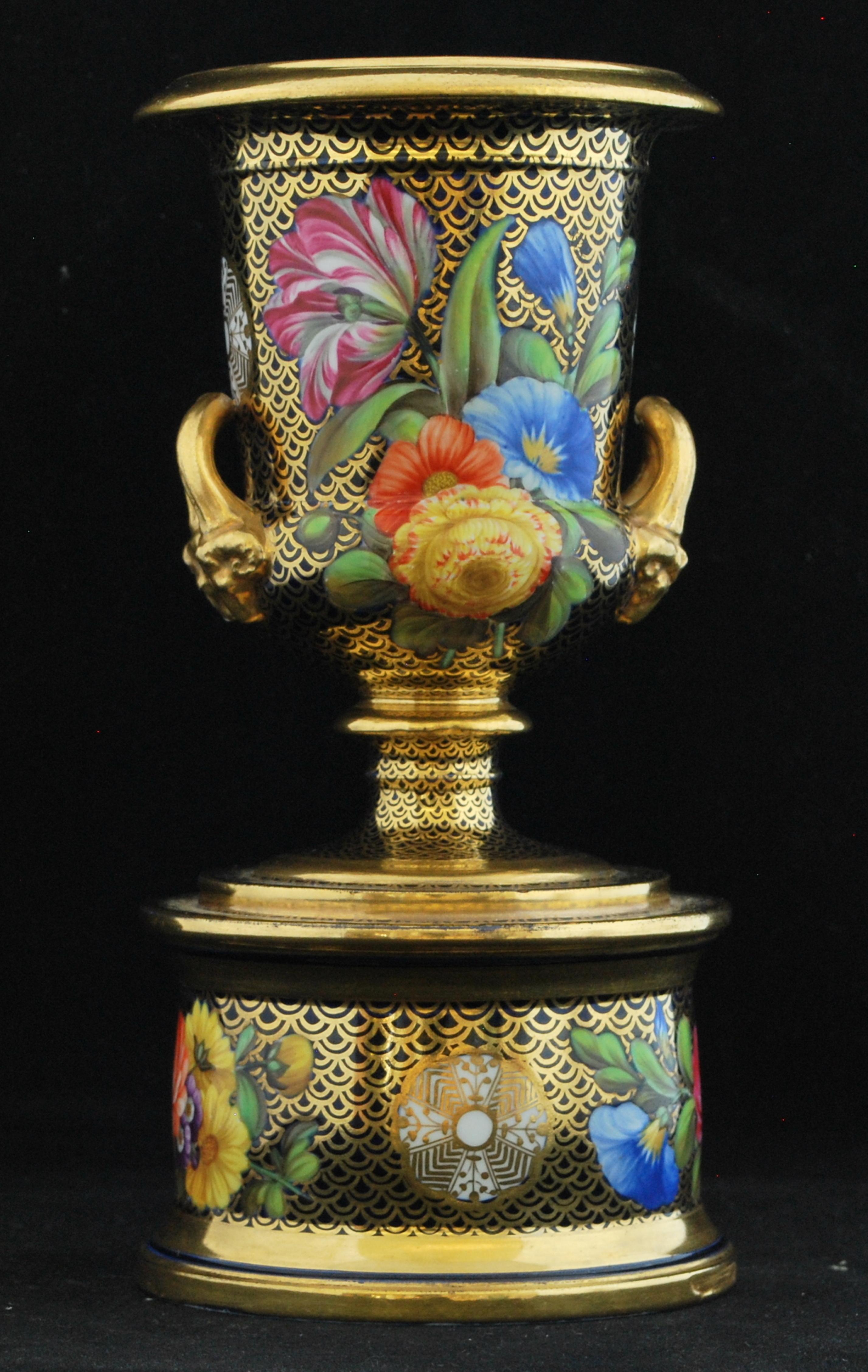 Classical meets regency: A miniature campana vase, decorated with pattern 1166. This pattern, despite its lasting popularity, has never been given a common name; perhaps because of the number of variations on it.

The flower painting is superb,