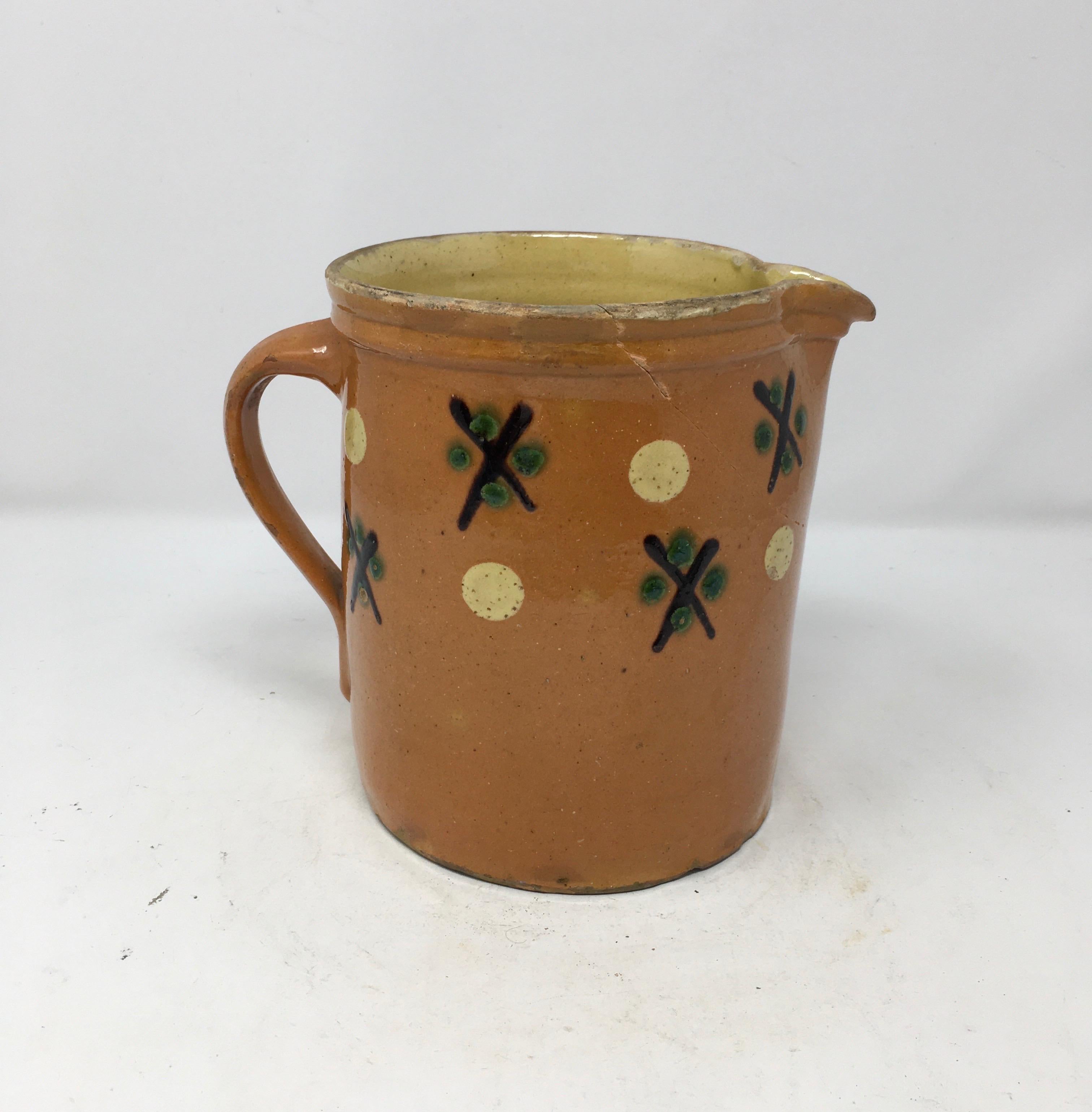 This colorful antique Alsatian pitcher has a wide mouth and a small spout. It is decorated with green, brown, yellow and terracotta color glazed swatches. It would also be lovely filled with flowers.

This piece weighs 2 lbs.
   