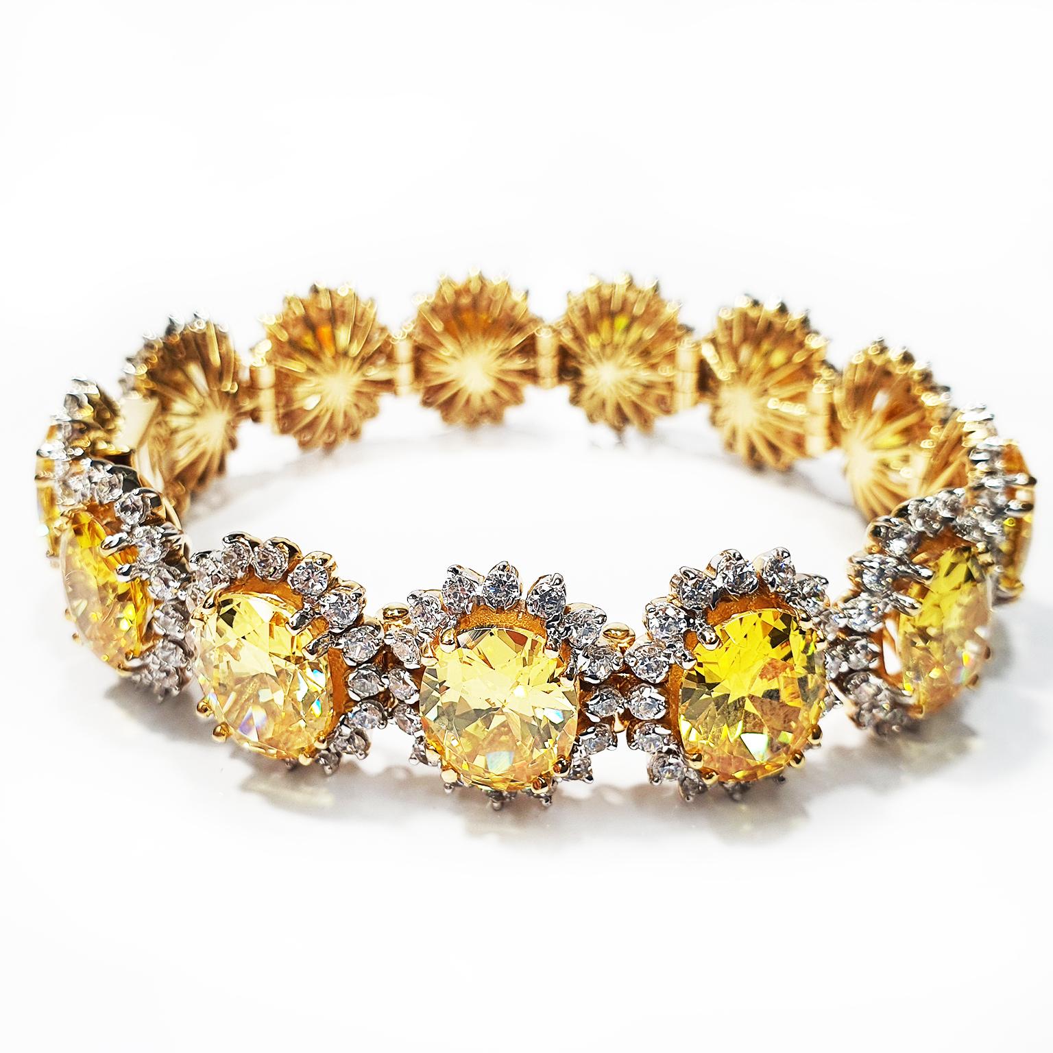The Swarovski crystal bracelet is crafted from 9K yellow gold with yellow and white Swarovski crystals. The bracelet contains 13 large 11mm x 9mm yellow colour matched oval Swarovski crystals with each oval surrounded by 16 x 2mm round white
