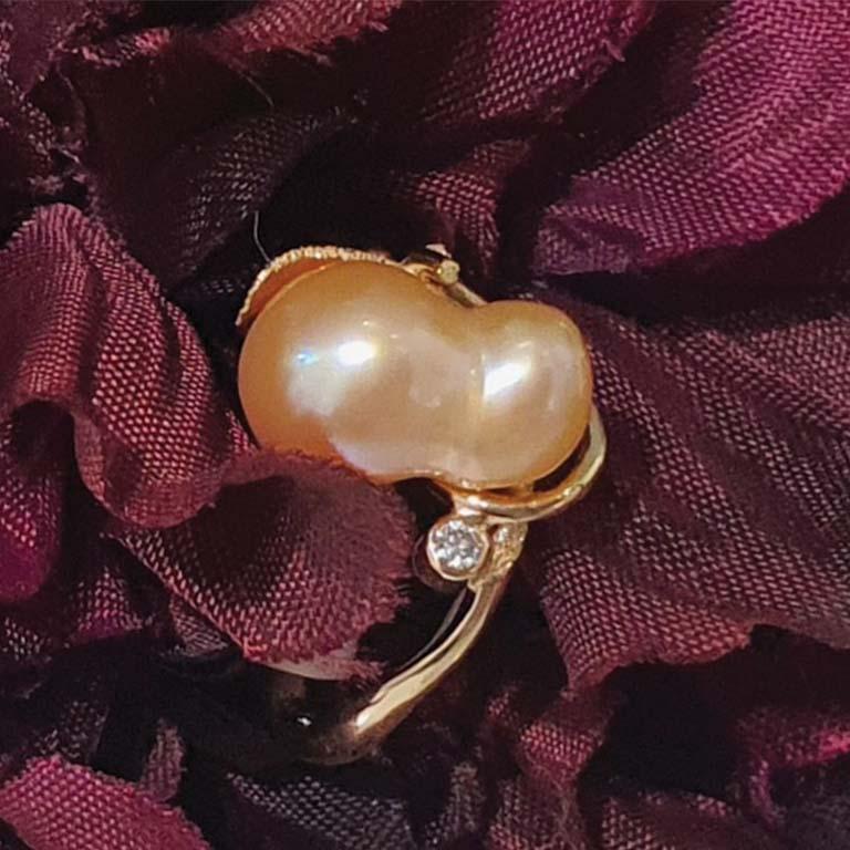 Paul Amey’s “Apricot” Pearl ring is a totally unique and completely handcrafted and created by Paul Amey in 9K yellow gold, featuring a 10mm x 8mm natural freshwater peanut pearl in apricot tones with a 2pt round EF SI brilliant diamond set to the