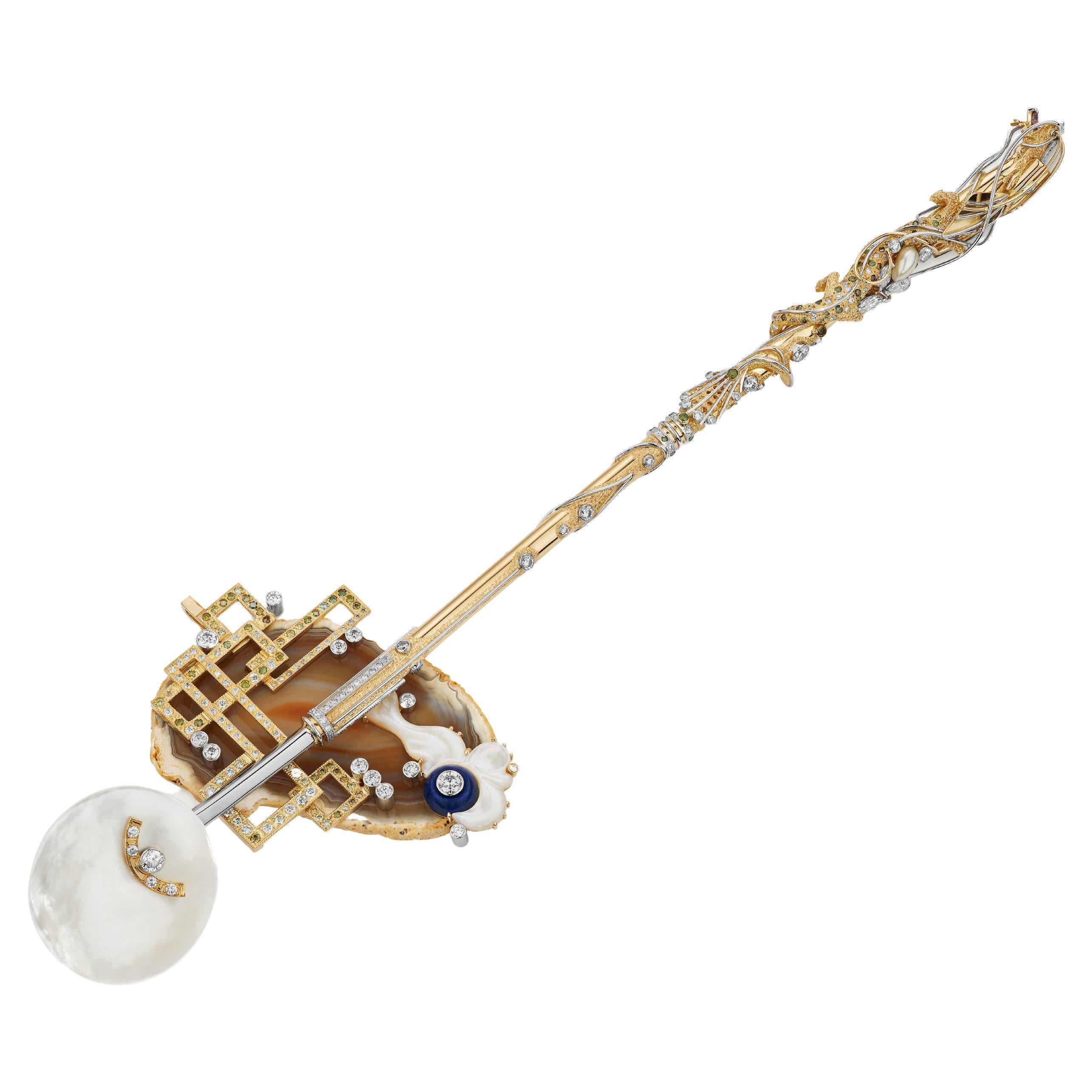 “DRAGON SPOON” and “CLOUD” Rest/Pendant

The “Dragon Spoon” is a caviar spoon with a stylized “Dragon” wrapped down the stem and features a 26pt heart shaped natural pink Argyle type diamond in his mouth. The “Dragon Spoon” is made from 18K yellow