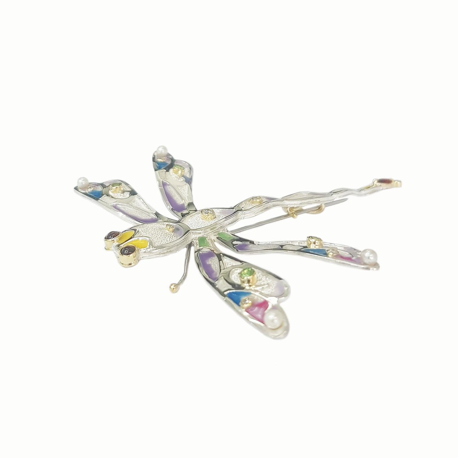 The Dragonfly Pendant-Brooch is a totally unique and completely handcrafted and created by Paul Amey.  The Dragonfly Pendant-Brooch was crafted from tarnish resistant Sterling Silver with diamonds, garnets, tsavorite garnets and pearls scattered