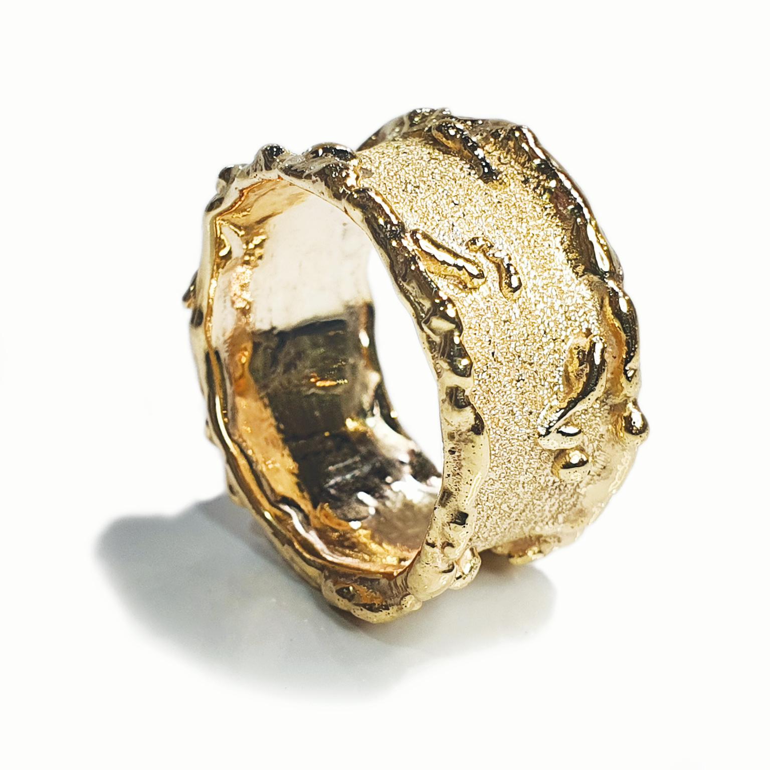 Paul Amey’s Gold Molten Edge ring was hand crafted from 9K Yellow Gold. The ring features a 11mm wide band, molten drips and is finished with Paul Amey’s signature texture. The ring weights 4.9 grams and is currently size O (GB) or 7.5 (US) but can