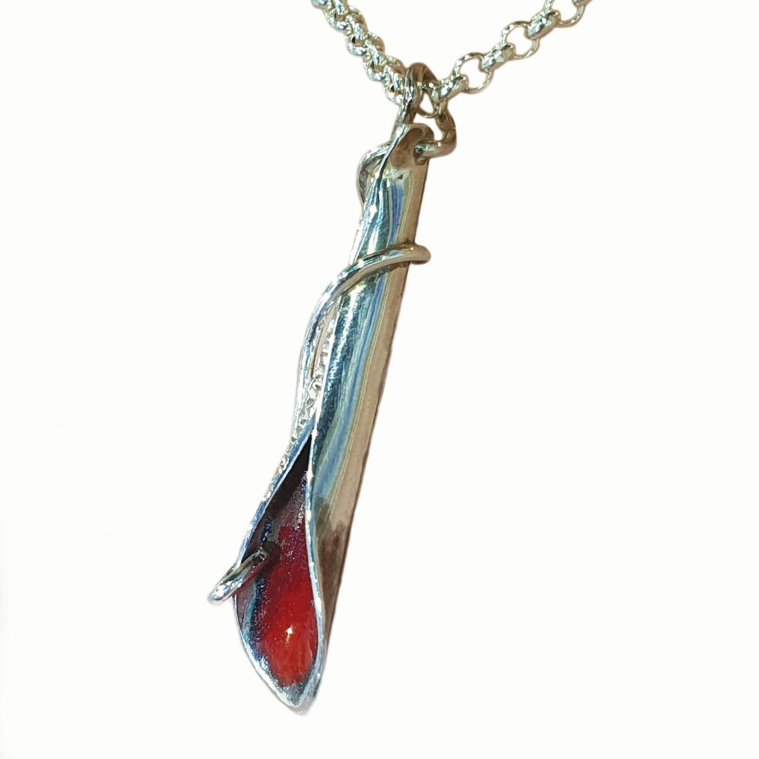 Paul Amey’s Red leaf pendant was crafted from tarnish resistant Sterling Silver. The pendant features Paul Amey’s signature pin finish texture and red enamel. The pendant weighs 2.5 grams and measures 39mm by 9mm.

The Red leaf pendant was designed