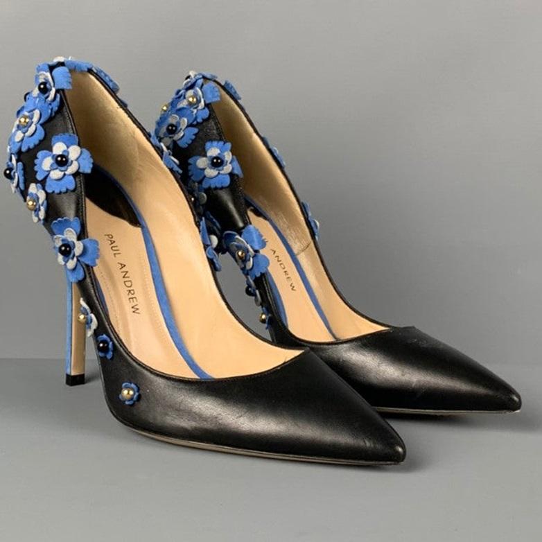 PAUL ANDREW pumps comes in a black & blue leather featuring floral applique details, pointed toe, and a stiletto heel. Handmade in Italy.
Very Good
Pre-Owned Condition. 

Marked:   37 

Measurements: 
  Heel: 4.25 inches 
  
  
 
Reference: