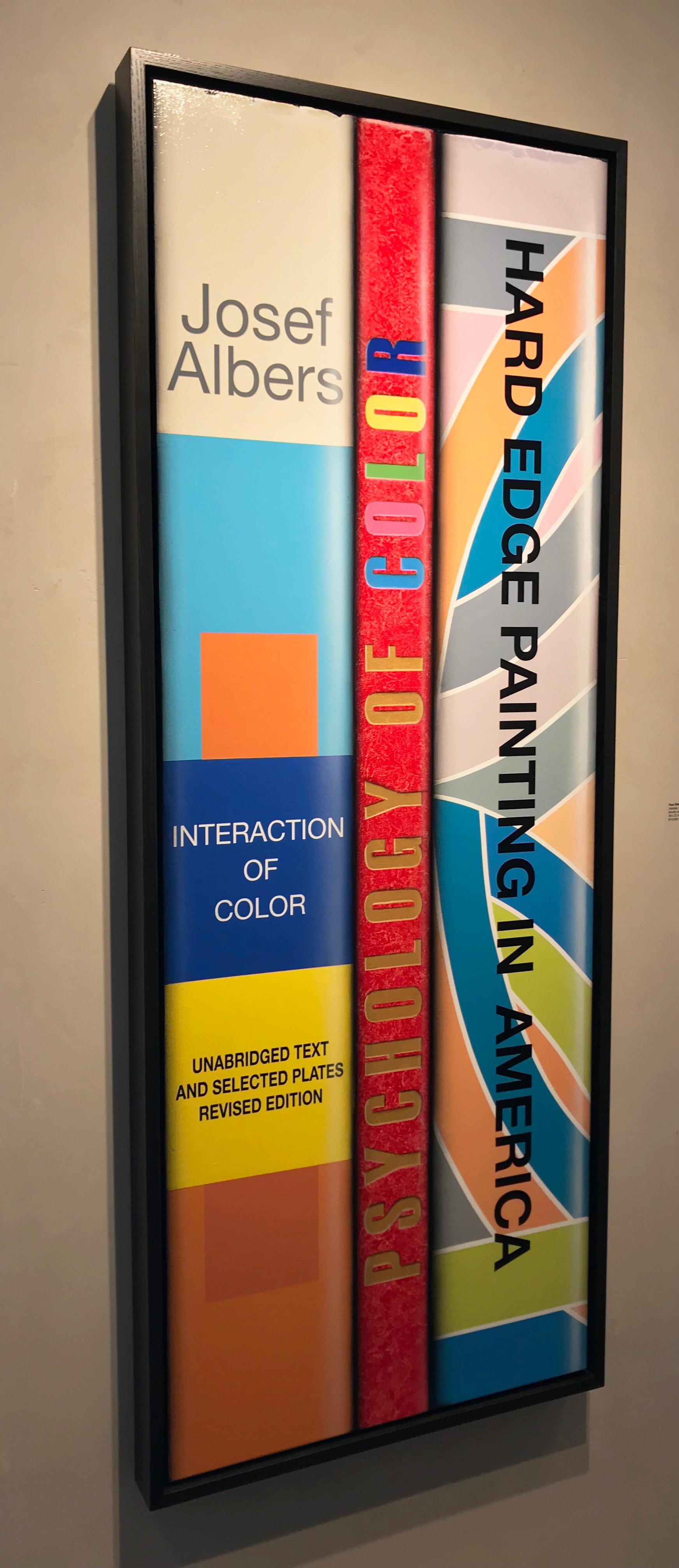 This hyper-realist acrylic painting of art book spines  Paul Béliveau depicts colorful spines of books demonstrates Béliveau's geometric sensibilities. This painting has a black wooden float frame and is signed verso. 
Paul Béliveau’s precisely