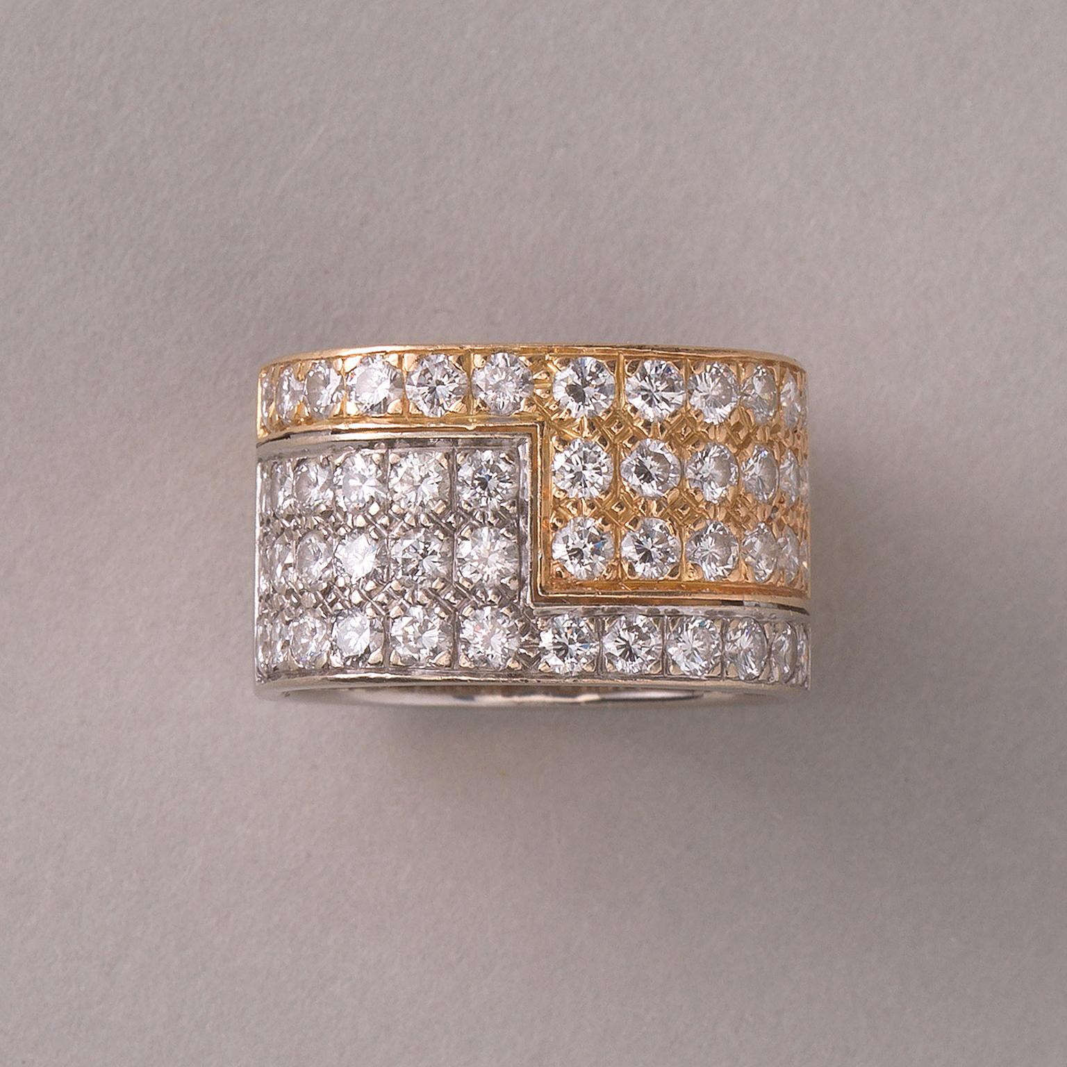 An 18 carat bi-color gold wide band ring with a yellow and white gold juxtaposed angle pavé set with 48 brilliant cut diamonds (app. 2.5 carat, G, VVS2) superbly designed and meticulously fabricated by the Swiss master jeweller Paul Binder, circa