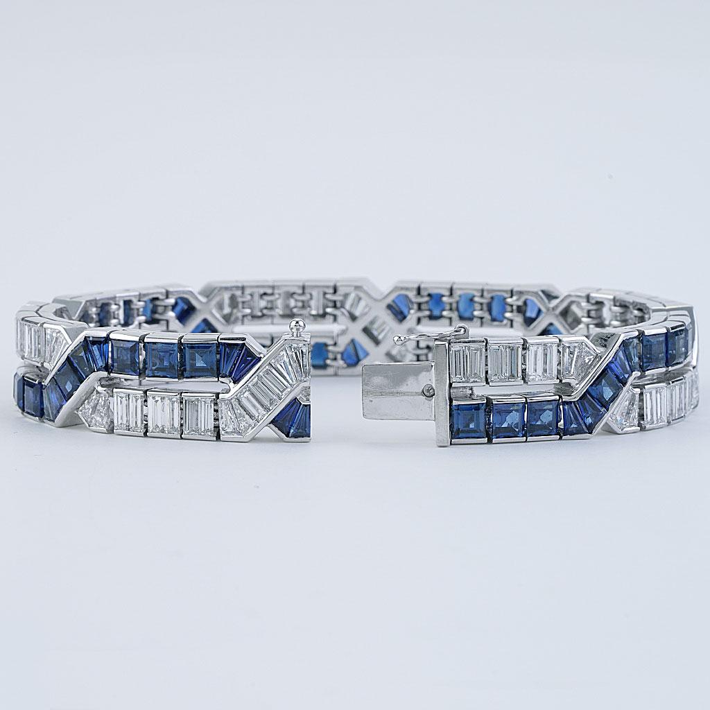 6.5 inches long made of 18k white gold. Approximately 20 carats of blue sapphires and 10 carats total of G color VS clarity Diamonds. With original box.