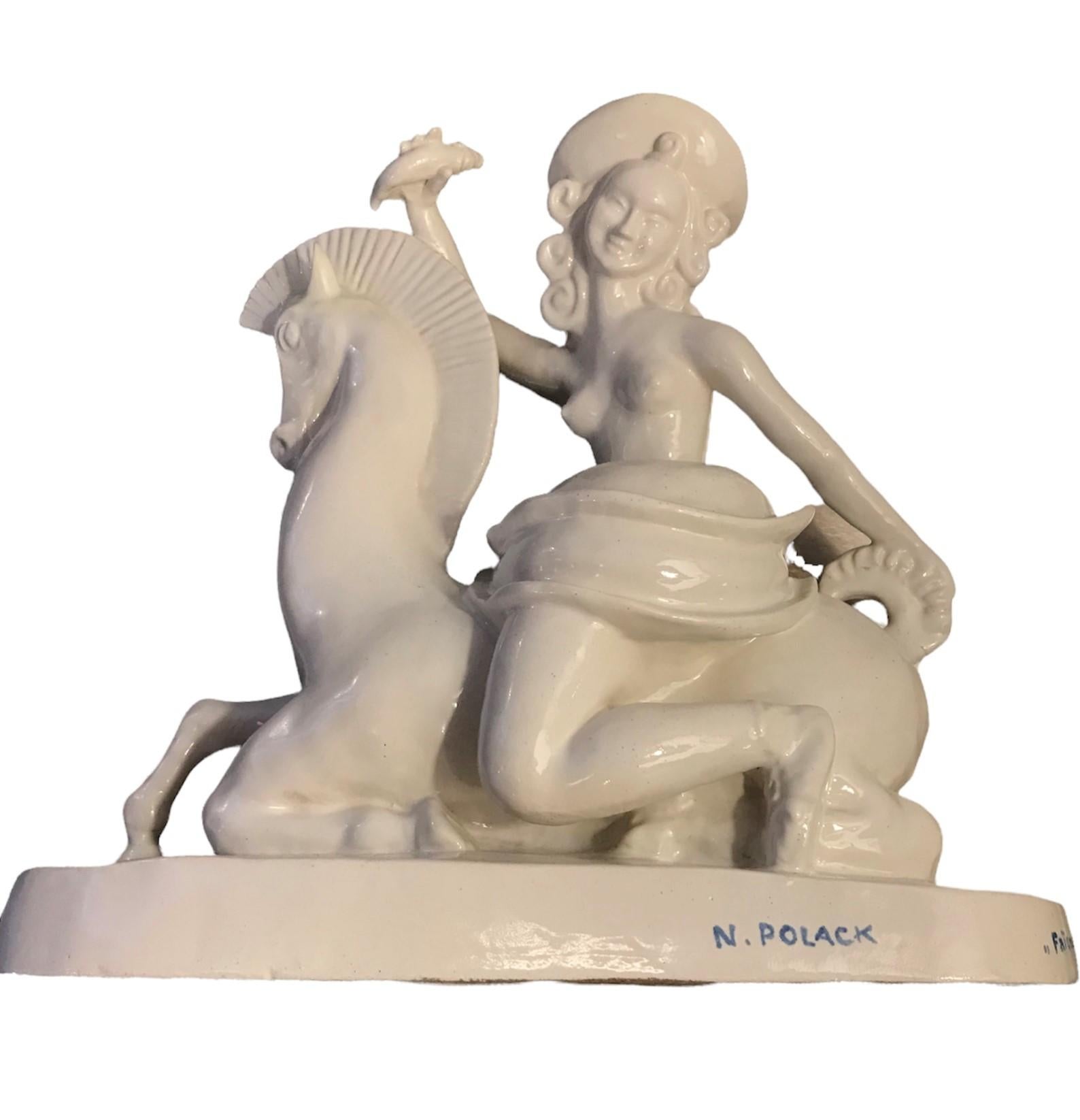 By sculptor Nelly Pollak, an Art Deco period white ceramic sculpture of horse with topless female rider or equestrienne, holding a fish, for Paul Bocquillon and his Faïence de Paris. Signed in blue underglaze N. Polack on the front and Faience de