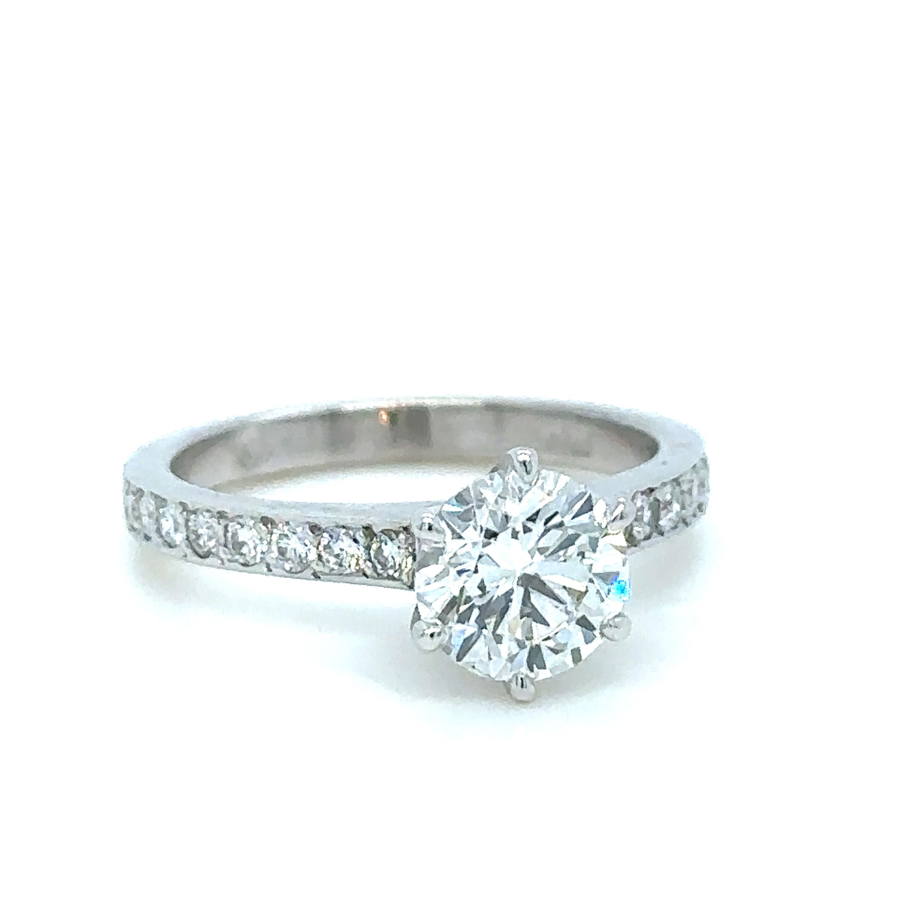 Unique features:

Paul Bram Diamond Engagement Ring.

l x 18ct white gold ring with one round brilliant cut diamond weighing 1.02ct, in 6-claw setting, flanked by sixteen round brilliant cut diamonds weighing a total of 0.23ct (colour: F, clarity: