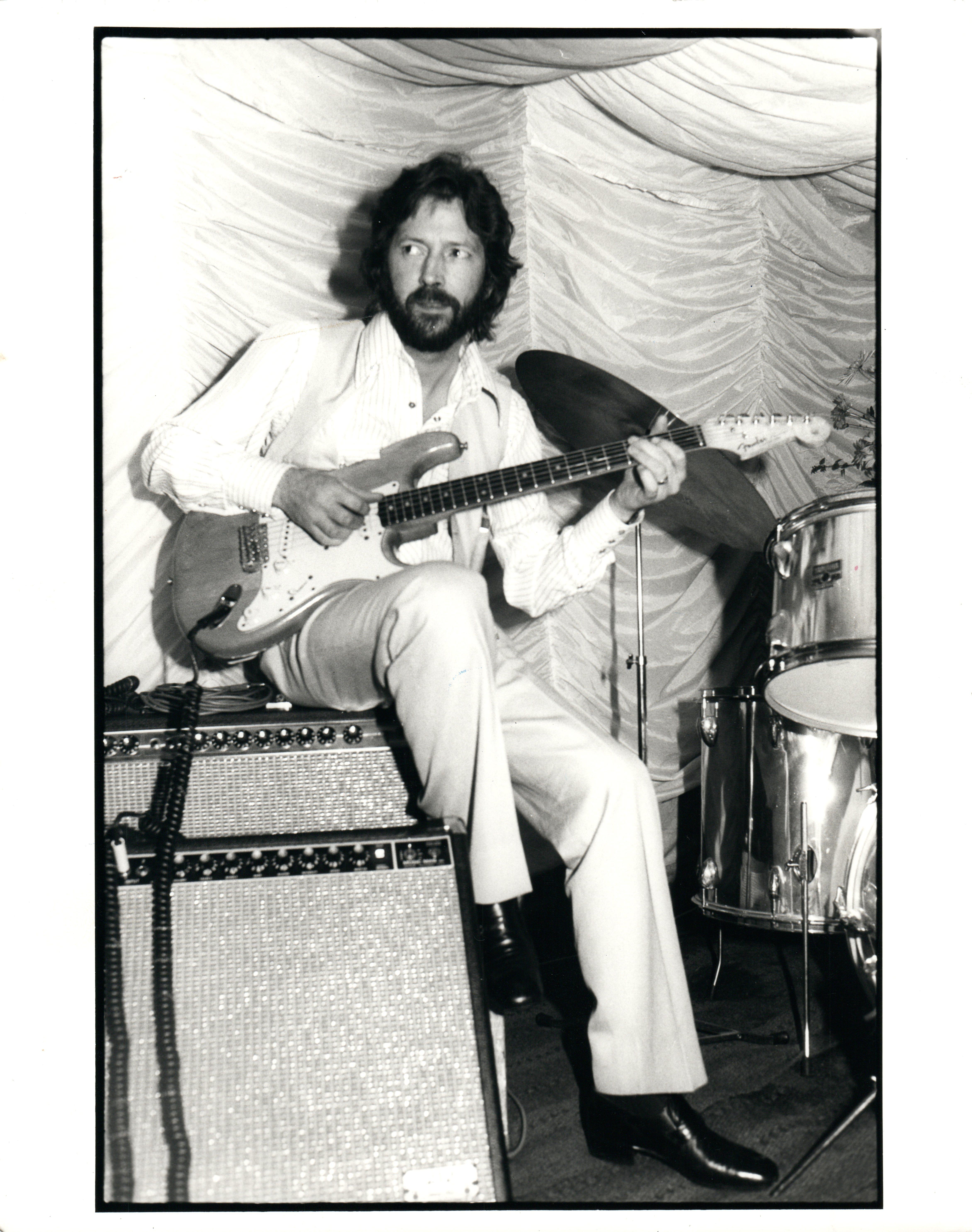 Paul Canty Black and White Photograph - Eric Clapton Sitting on Amp, Playing Guitar Vintage Original Photograph