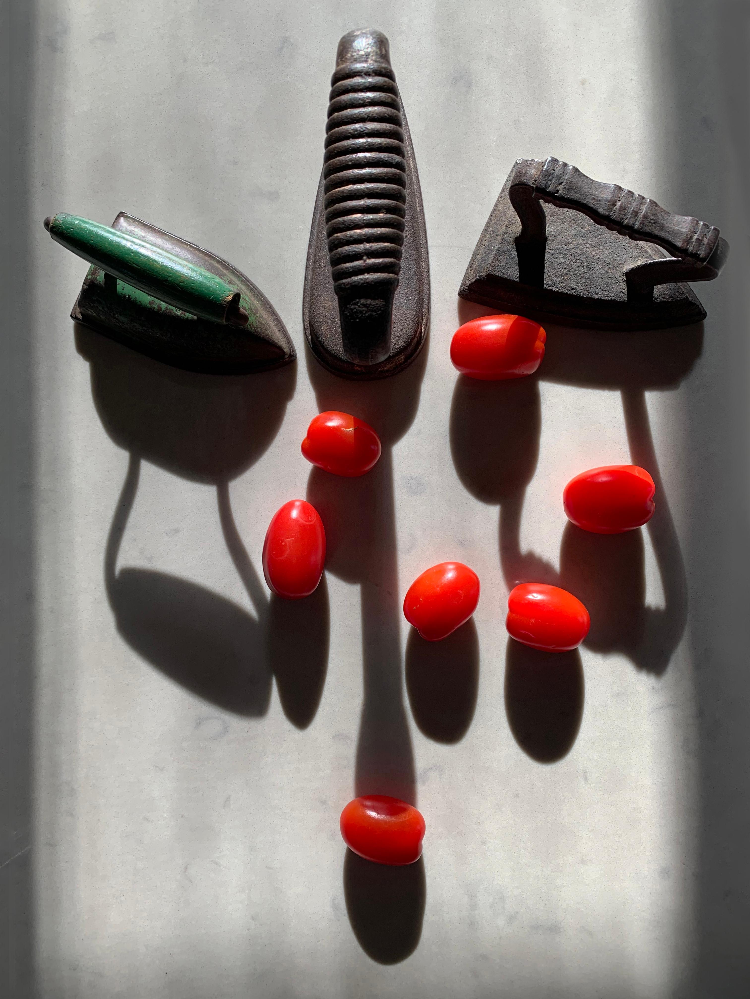 Irons and Tomatoes: still life color photograph w/ abstract shadow patterns, lg