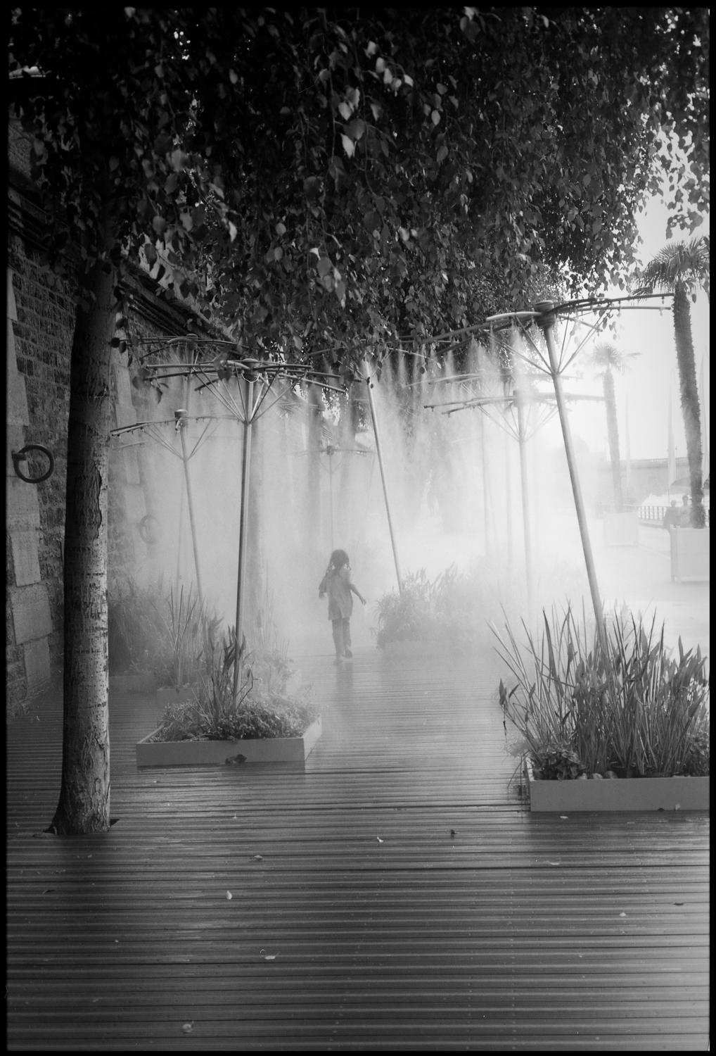 Paul Cooklin Black and White Photograph - Edition 1/10 - Young Girl Running, Paris, France, Silver Gelatin Photograph