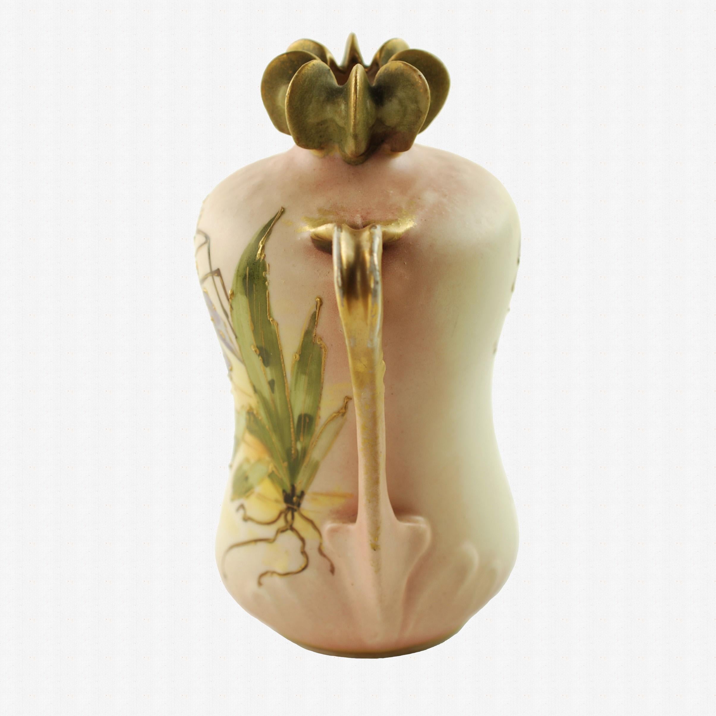 This early 20th century Art Nouveau porcelain vase was designed by Paul Dachsel for Riessner, Stellmacher & Kessel Amphora of Turn-Teplitz, Bohemia. The piece has an organic squash-like form and features Dachsel's distinctive ribbed mouth design at