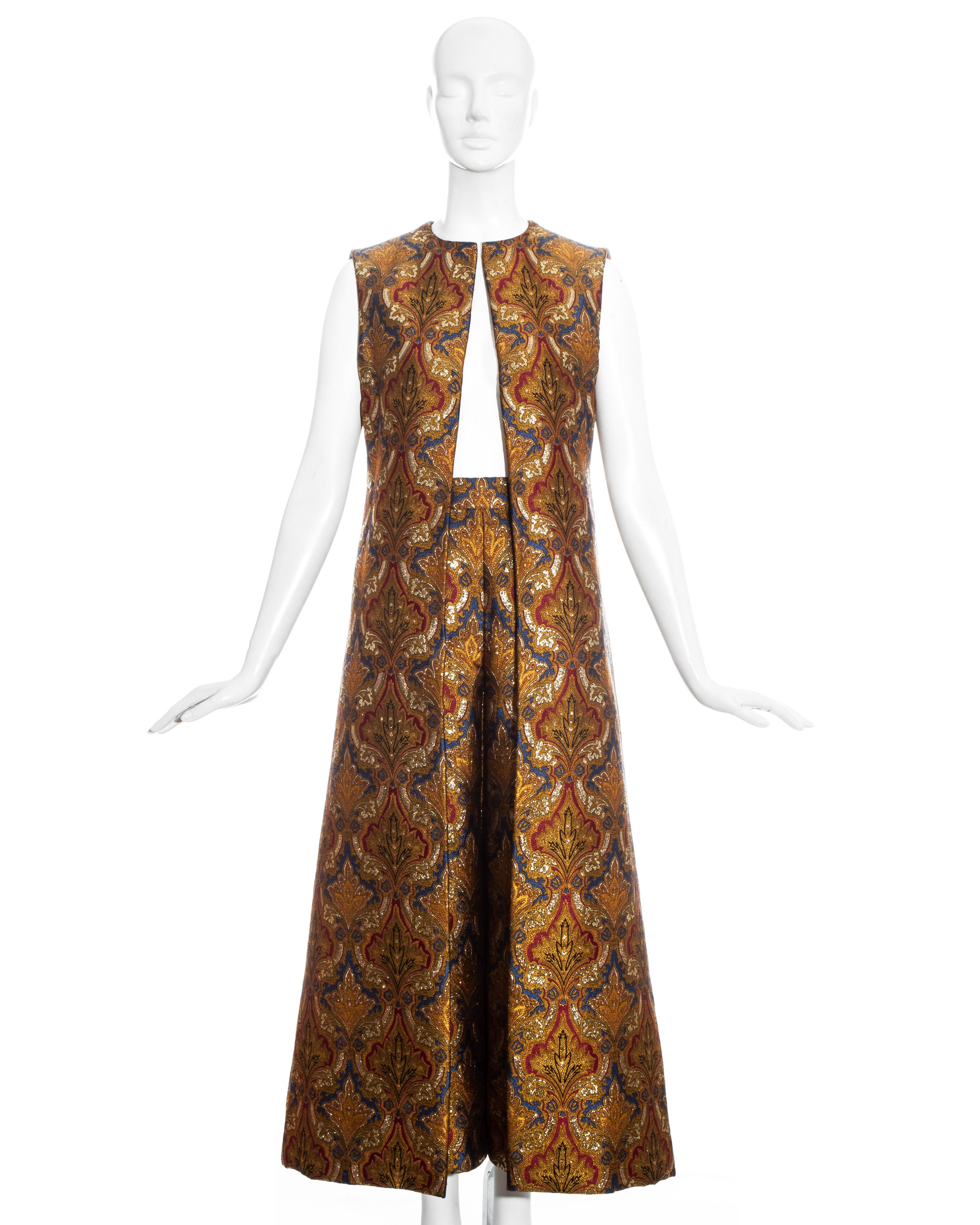 Paul Daunay gold lamé jacquard couture evening ensemble comprising: long-line waistcoat lined with purple silk and high rise a-line skirt with inverted pleats and two side pockets.

Paul Daunay designs were hand made to a Haute Couture standard in