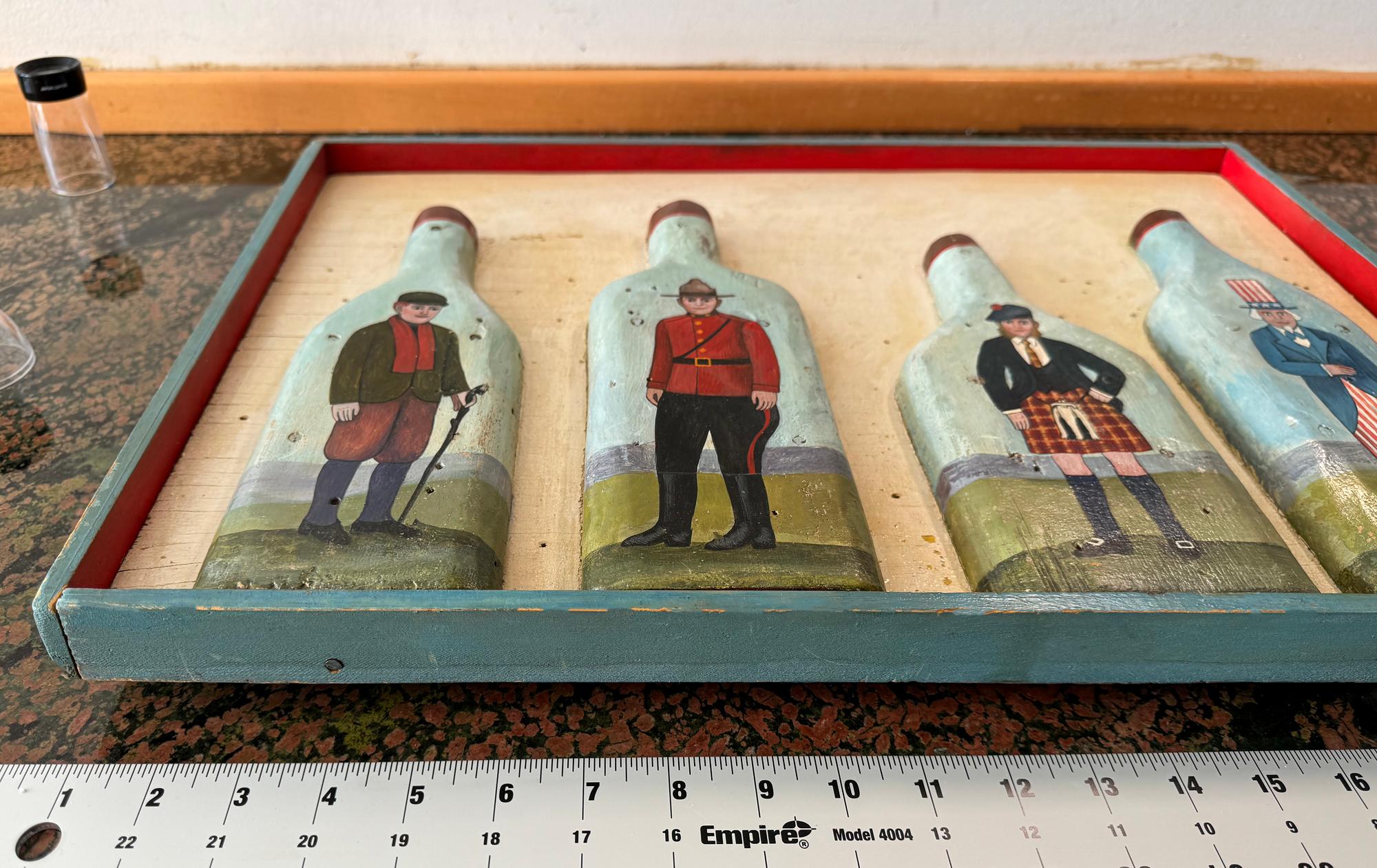 Famed American Illustrator Paul Davis of 1968 Che Guevara poster fame illustrates an article about  Whisky from Ireland, Scotland, Canada, and the United States.  He executes the work in a folk art style in relief sculpture.  The four bottles are