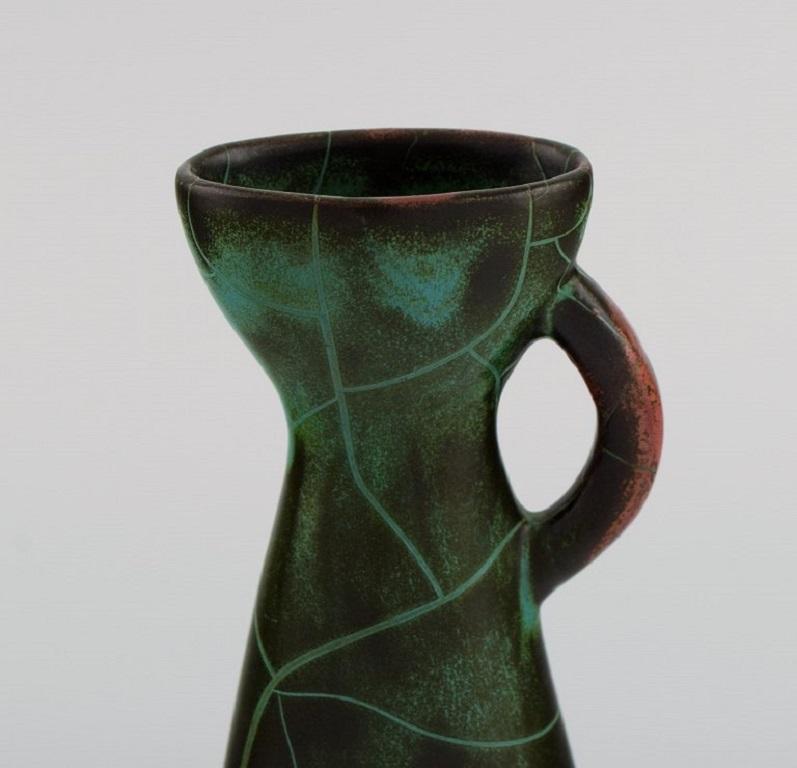 Paul Dresler (1879-1950) for Grotenburg, Germany. 
Jug in glazed stoneware. Beautiful crackle glaze in shades of red and green. 
1930s / 40s.
Measures: 14.5 x 8.5 cm.
In excellent condition.
Stamped.
