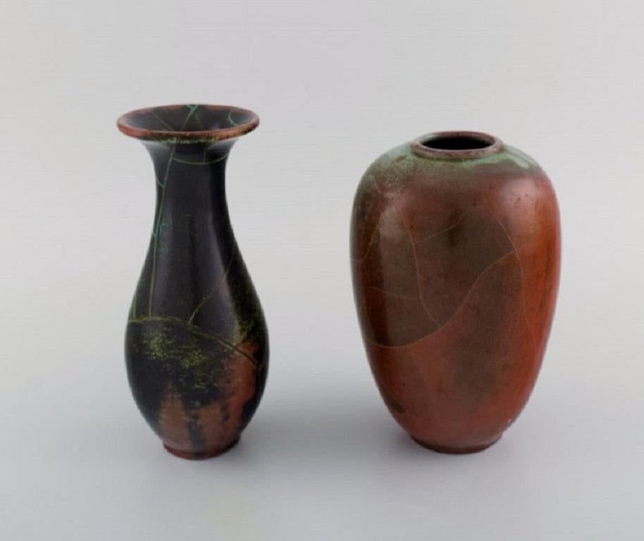 Paul Dressler for Grotenburg, Germany. Two vases in glazed stoneware. 
Beautiful crackle glaze in shades of red and green. 1940s.
Largest measures: 18 x 12 cm.
In excellent condition.
Stamped.