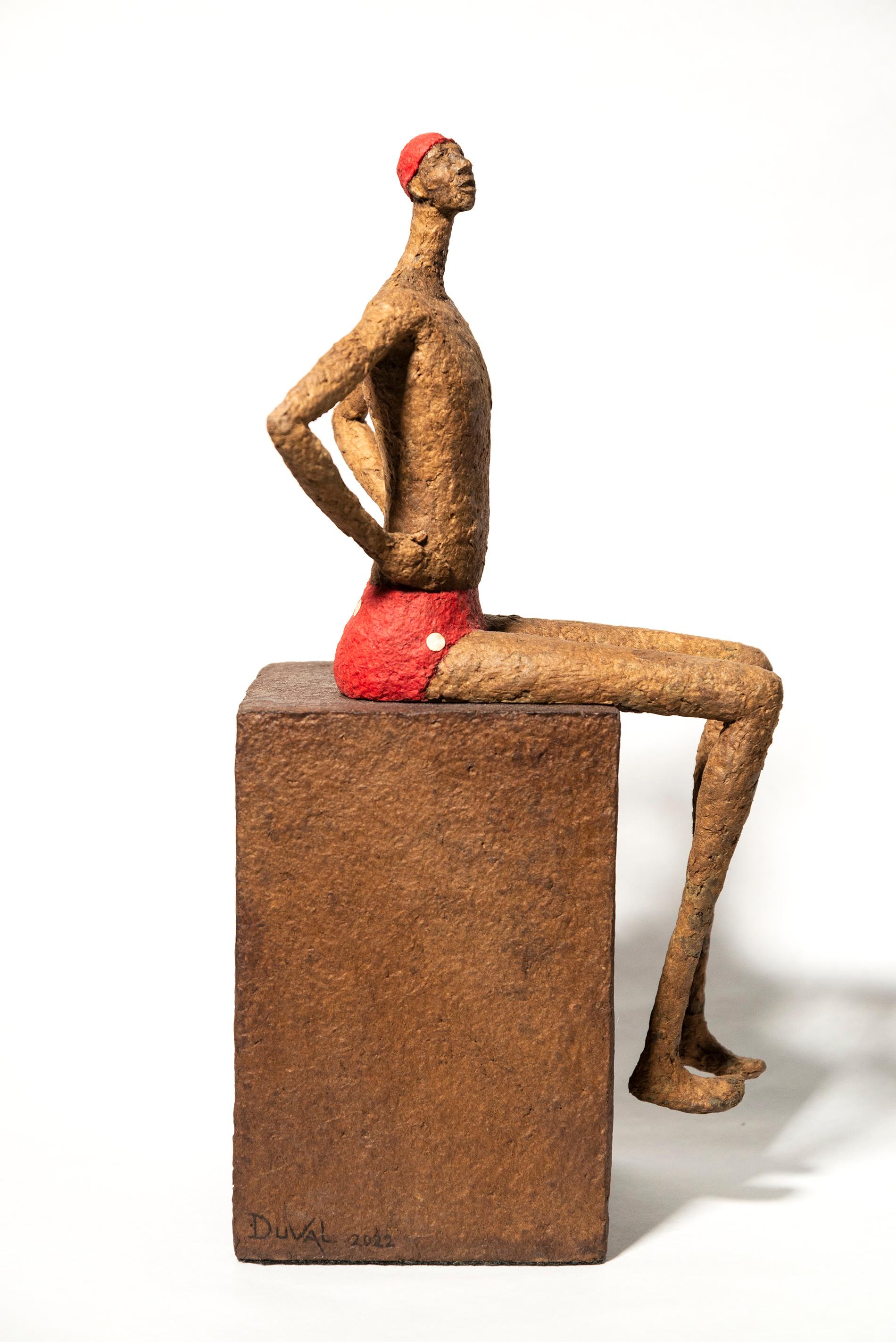 La série de petites sculptures figuratives de table de l'Artistics québécois Paul Duval capture l'essence de personnages individuels. Façonné à la main à partir de fil de fer et de papier mâché, chaque personnage est unique. Ici, il s'agit d'un
