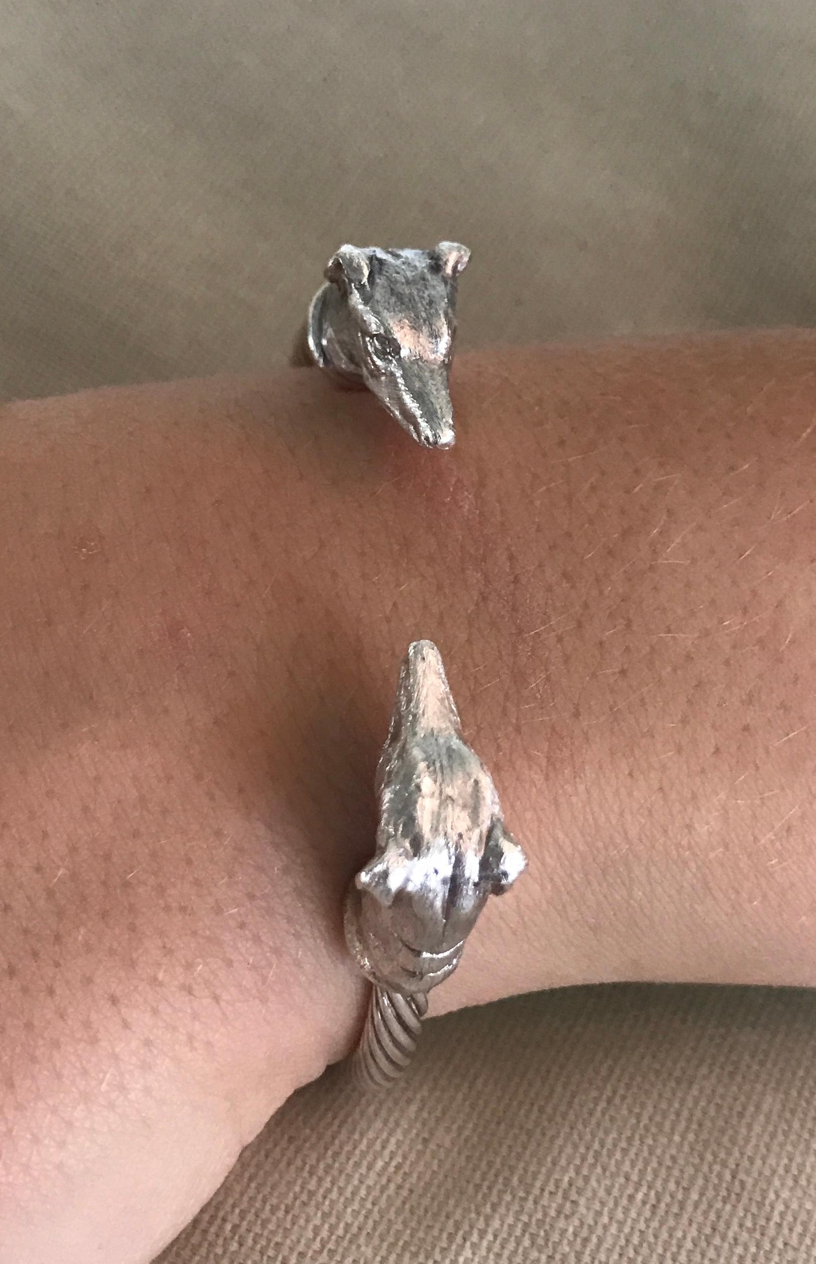 Intricately hand carved dog miniatures of Greyhound Heads (details in photos) on a sterling silver twisted bangle are made by England’s Paul Eaton who is possibly the world's best miniature sculptor of dogs and animals and a master gold/silversmith.