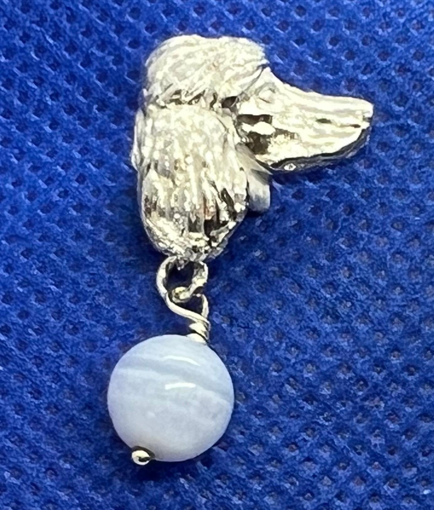 From Great Britain Paul Eaton's charming sculpted sterling silver dog heads of a Poodle are made into traditional clip on earrings with blue lace agate drops (.63
