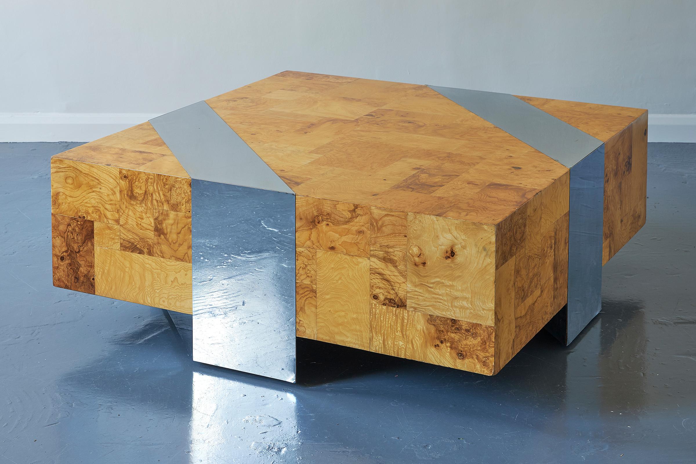 A late 20th century Brutalist coffee table by Paul Evans (American, 1931-1987) for Directional Furniture, of his signature patchwork style employed in the 1970s, of square shape, patched burl olive wood with trapezoid inserts of chromed steel.