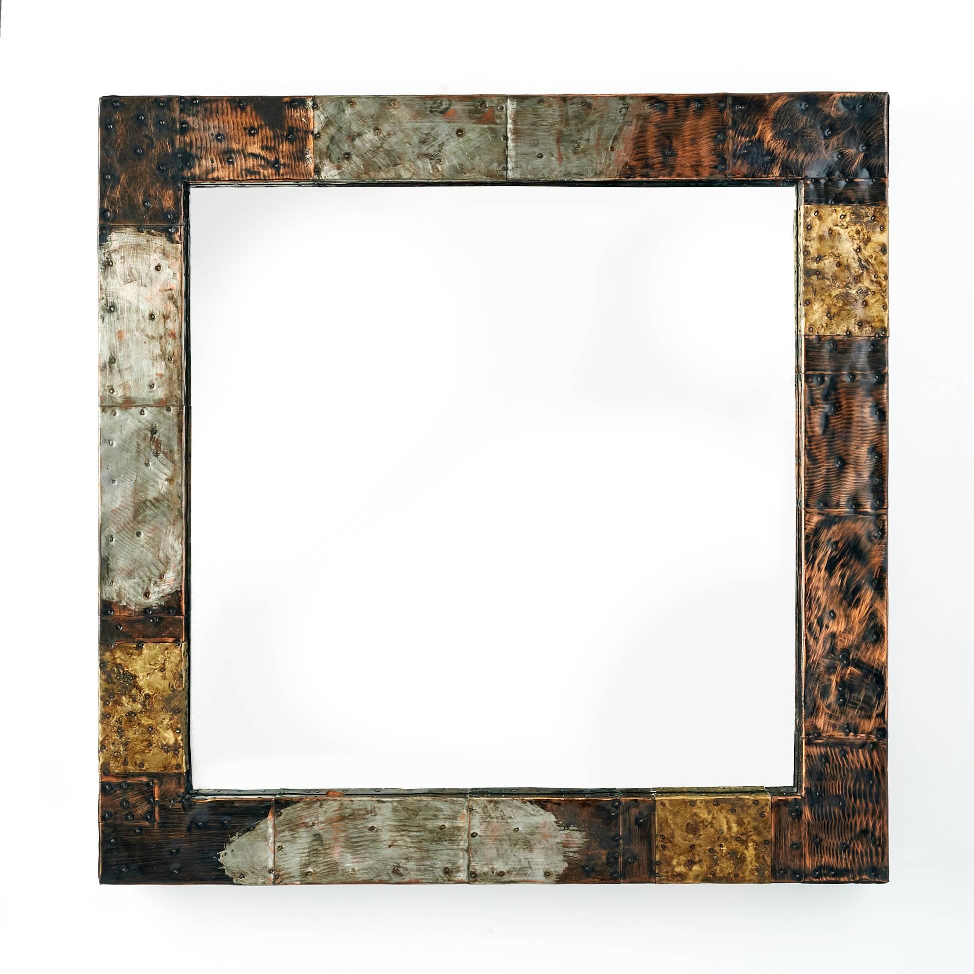 Paul Evans (1931–1987).

A beautifully crafted patchwork mirror in patinated and welded copper, brass, and steel by American Craft movement master Paul Evans. Poised between handicraft and industrial design, this iconic piece is an excellent