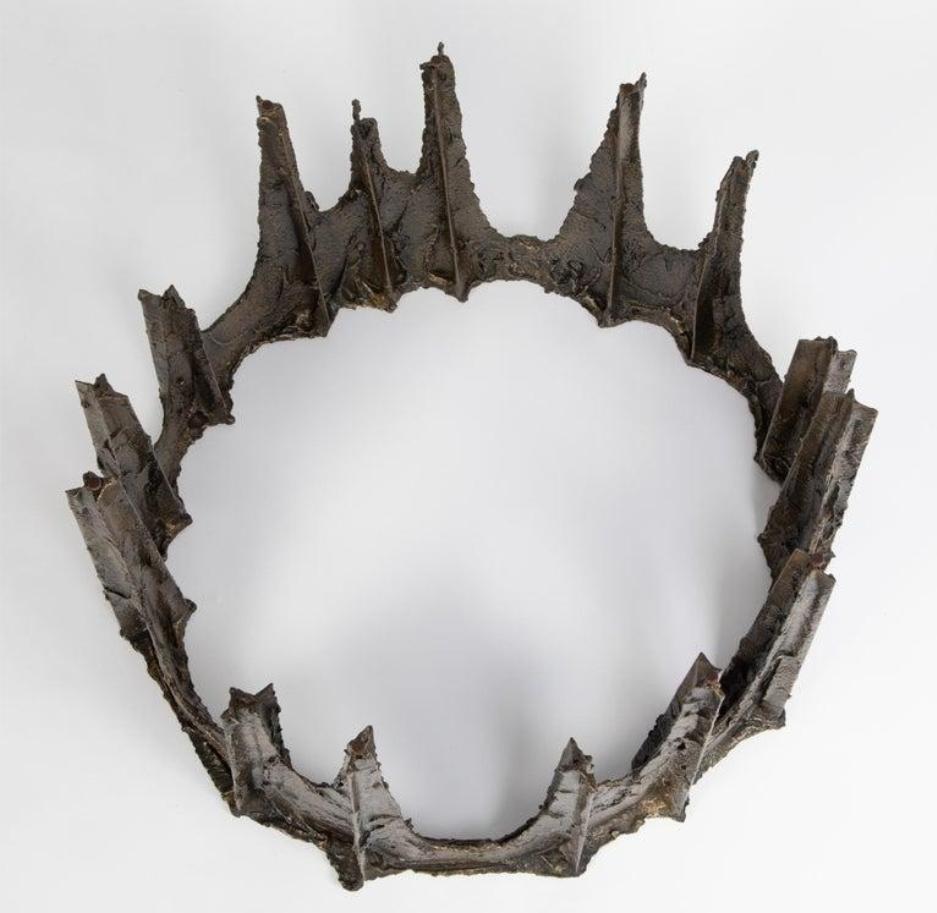 A sculpted bronze and glass “Stalagmite” coffee table, the thick round glass top sits on top of a bronze base, decorated with thick impasto like application of bronze over an iron framework. A magnificent example of Paul Evans’ sculptural work – a