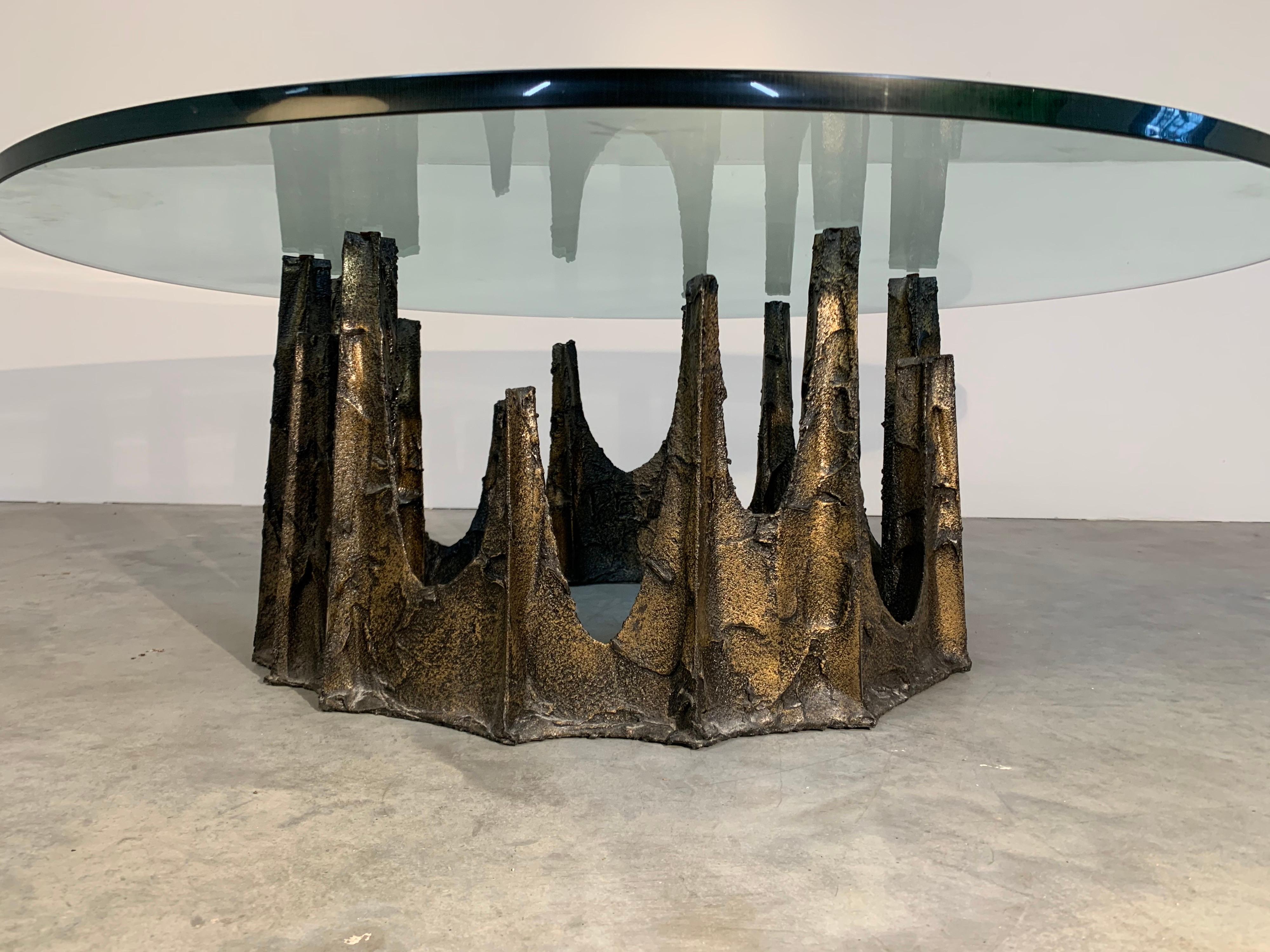 An original Paul Evans model PE-128 cocktail table having sculpted bronze Brutalist base underneath of a substantial 3/4” thick tempered glass top from the ‘Sculptured Metal Collection’ for Directional.
Signed PE70. Created in 1970.
In beautiful