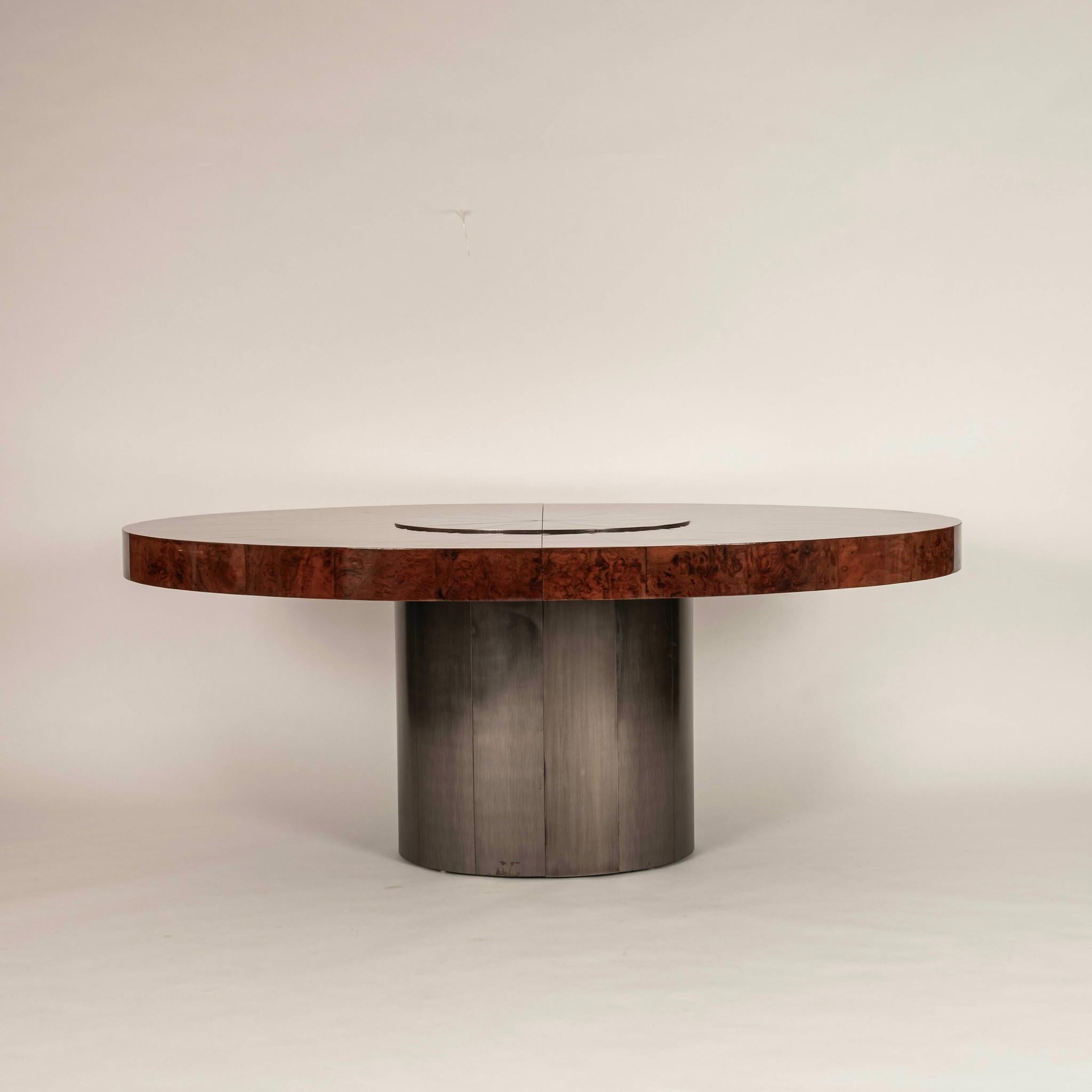 Vintage Paul Evans Cityscape dining table composed of lacquered burl wood and chrome. The table comes with 2 leaves, allowing it to extend to a total width of 113.25 inches. This piece has been professionally restored.