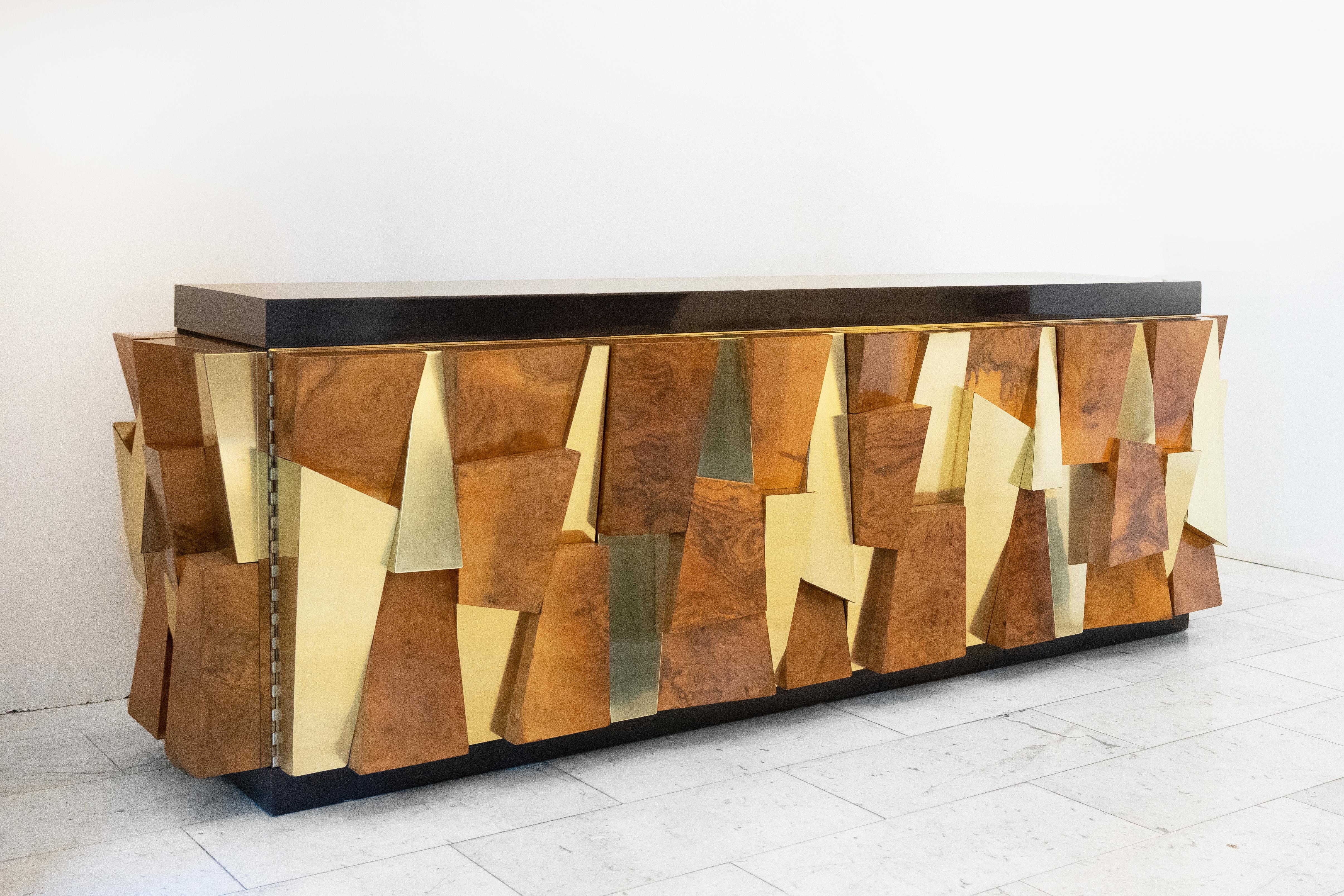 This exquisite and rare Faceted Cabinet (PE 380) was designed and completed by Paul Evans in his New Hope, Pennsylvania studio in 1980. Made of rich burled walnut, mirror polished brass, and a gel-coated fiberglass top, the console features 4