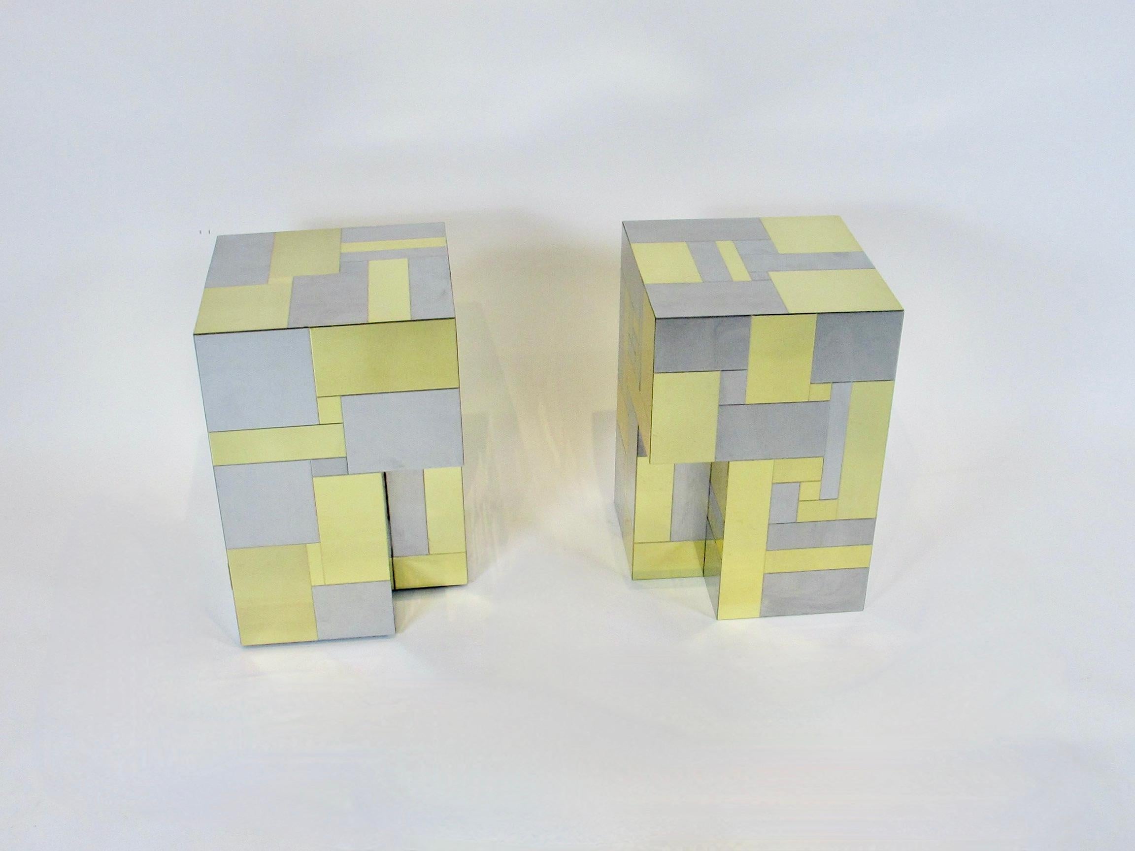 Pair of Paul Evans designed cubes from the city scape series for directional. Each cube is a patchwork of brushed stainless steel and polished brass geometric forms. Each measures 12 x 12 x 18 tall. The pair can be used as side or end tables or with