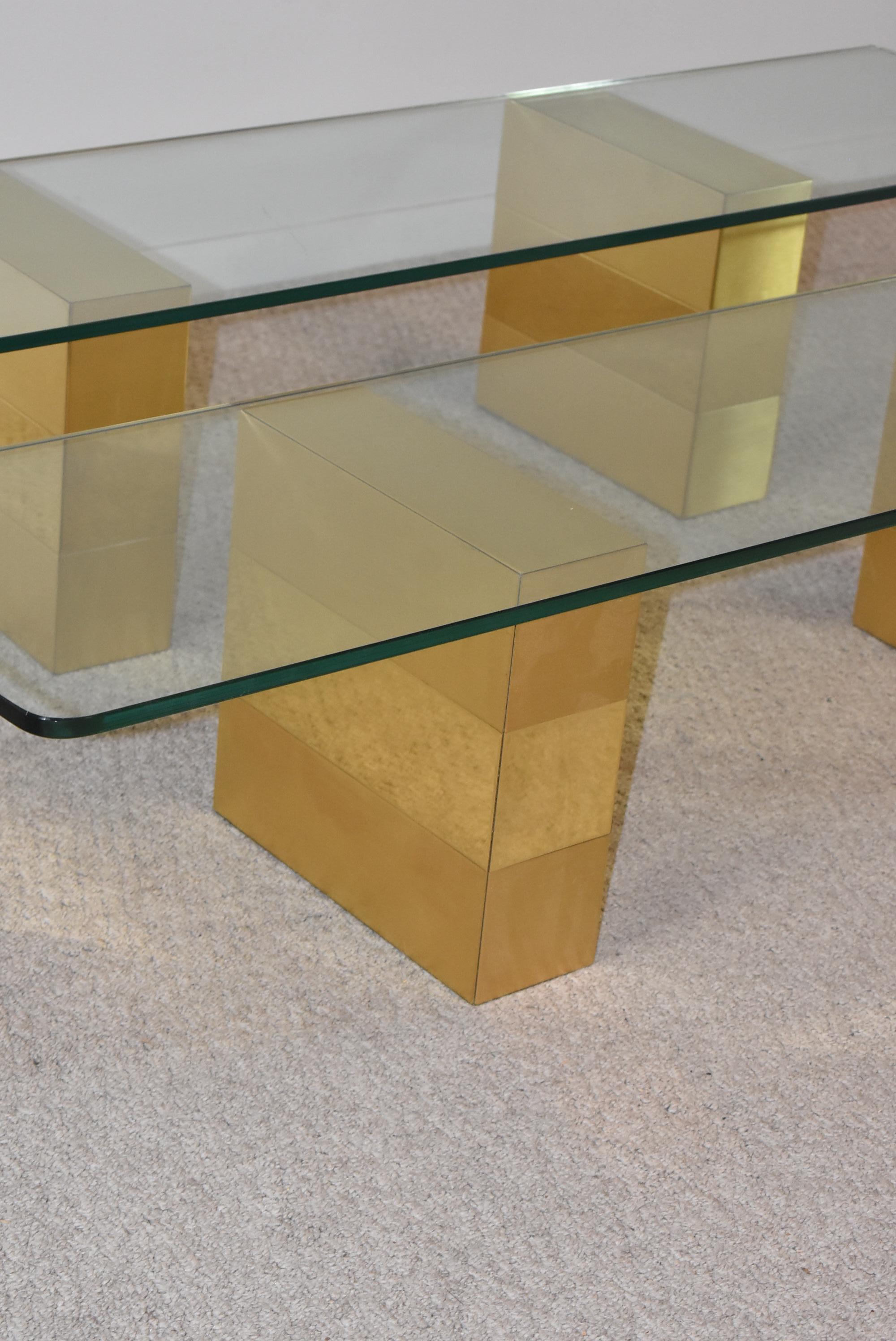 These beautiful brass and glass cityscape shelves by Paul Evans could be used as a floating shelf or a floating credenza. The brass bases are 14