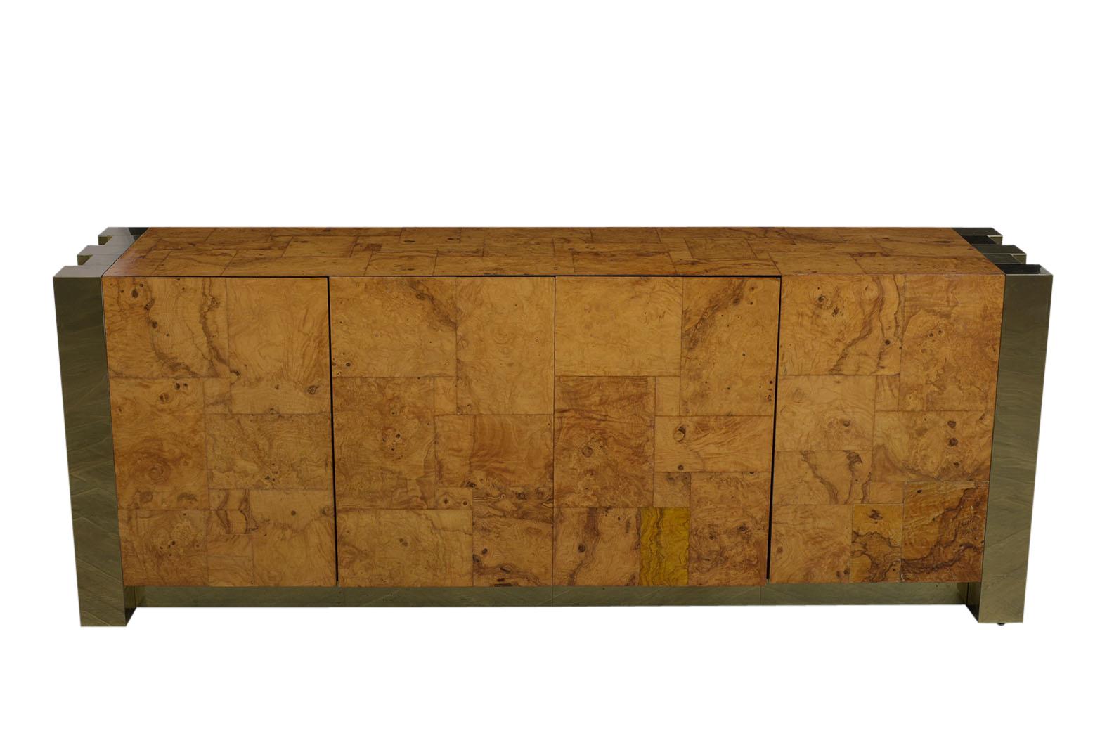 This 1970s Cityscape Credenza designed by Paul Evans has been newly restored, features it's original large brass accents along the sides/bottom, and its original golden finish. This magnificent piece is covered in an elegant burled wood veneer, has
