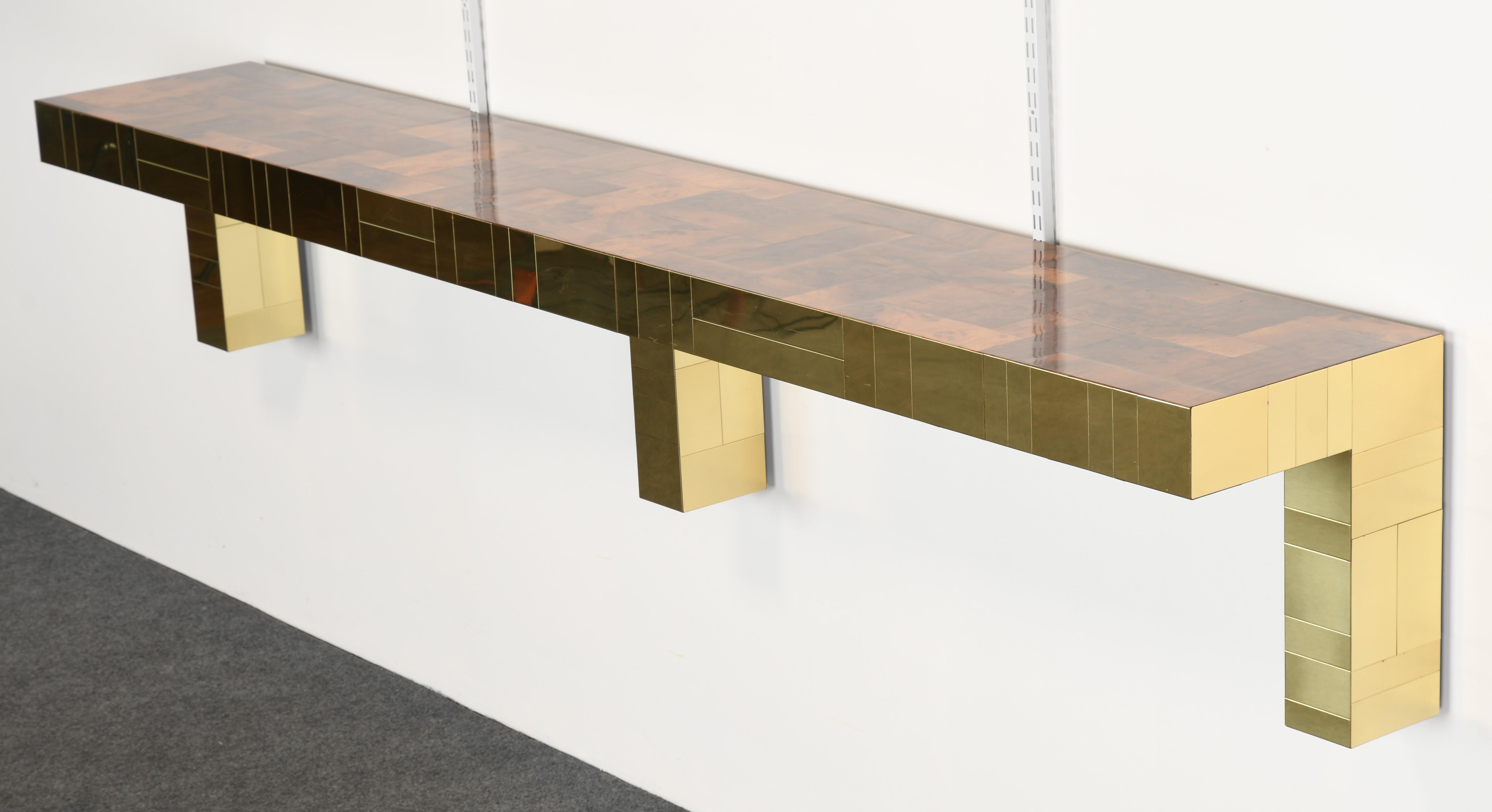 A Mid-Century Modern Paul Evans cityscape console table for Directional, USA. This very large monumental console table is stunning with a brass base and walnut burl top. Signed underside. The table is in very good condition.

Dimensions: 18.13