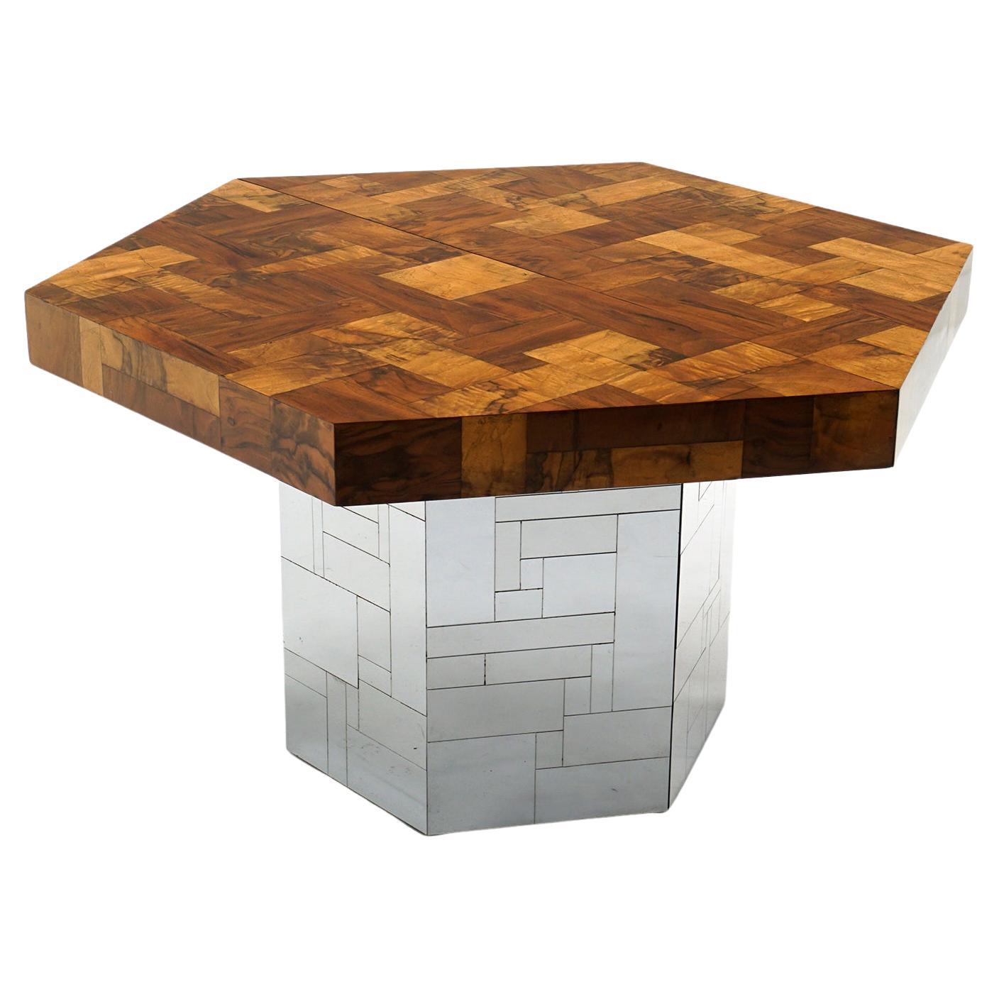 Stunning extension dining table designed by Paul Evans for his Cityscape series and manufactured by Directional.  Patchwork burl top and chrome base.  Without leaves it is a 47 inch hexagon. There are two 24 inch leaves that convert the top to an
