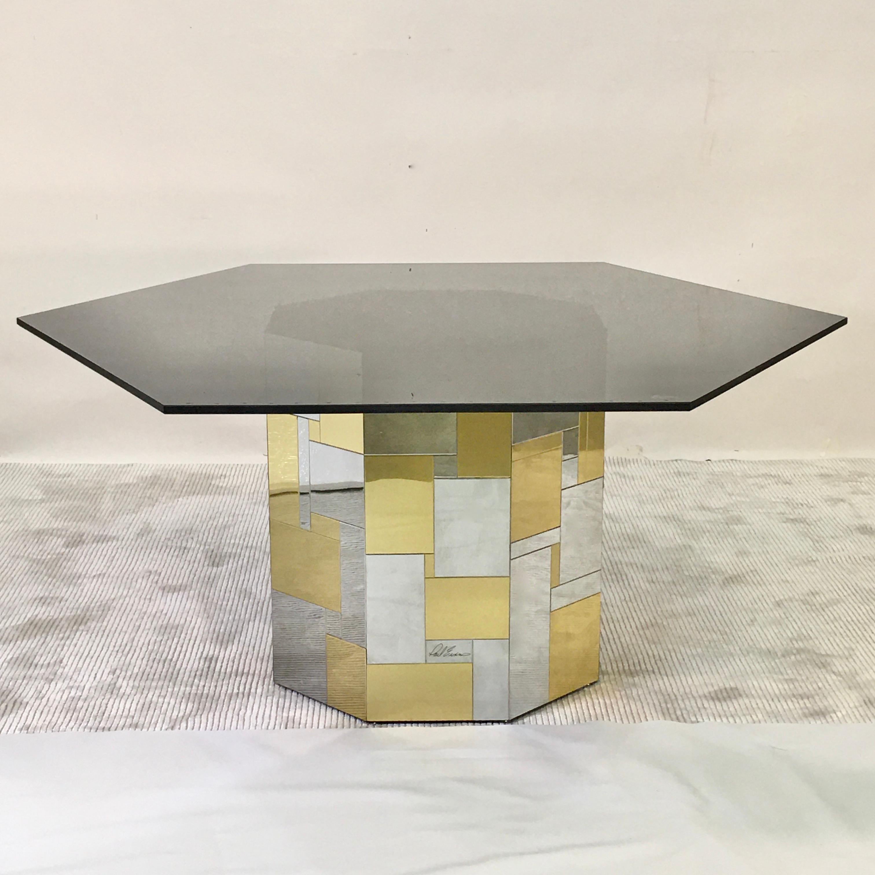 Hexagonal smoked black glass top on a signed Paul Evans brass and chrome patchwork tiled octagonal pedestal drum base. 
From his Cityscape Collection for Directional, 1972.
Total height 25 inches. Pedestal base alone is 24.5 inches high by 22.25