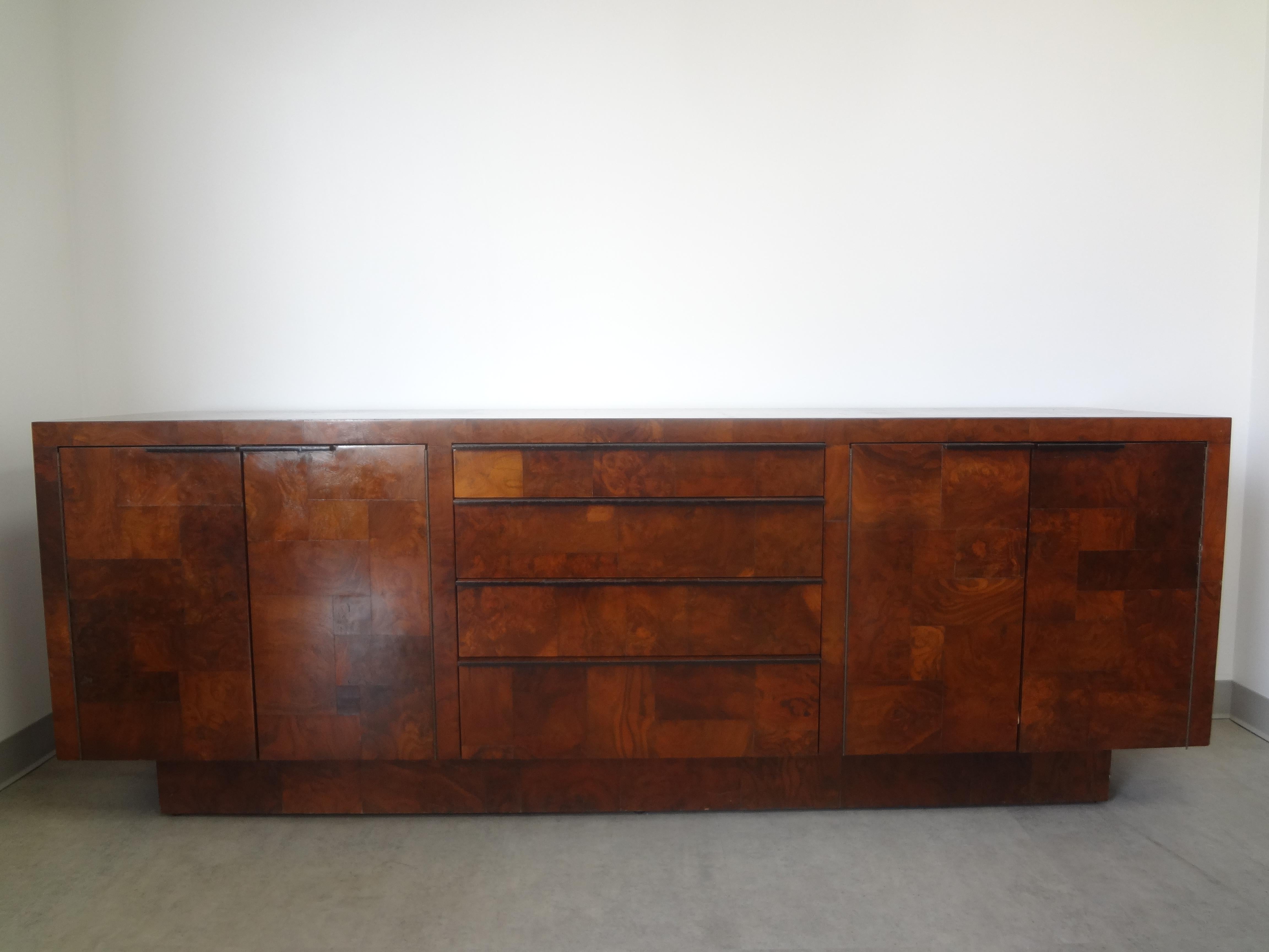 Paul Evans Cityscape patchwork burlwood credenza. This stunning long mid-century Paul Evans for Directional credenza or chest is comprised of cabinets on either side each with a shelf, 4 drawers in the center resting on a raised plinth.