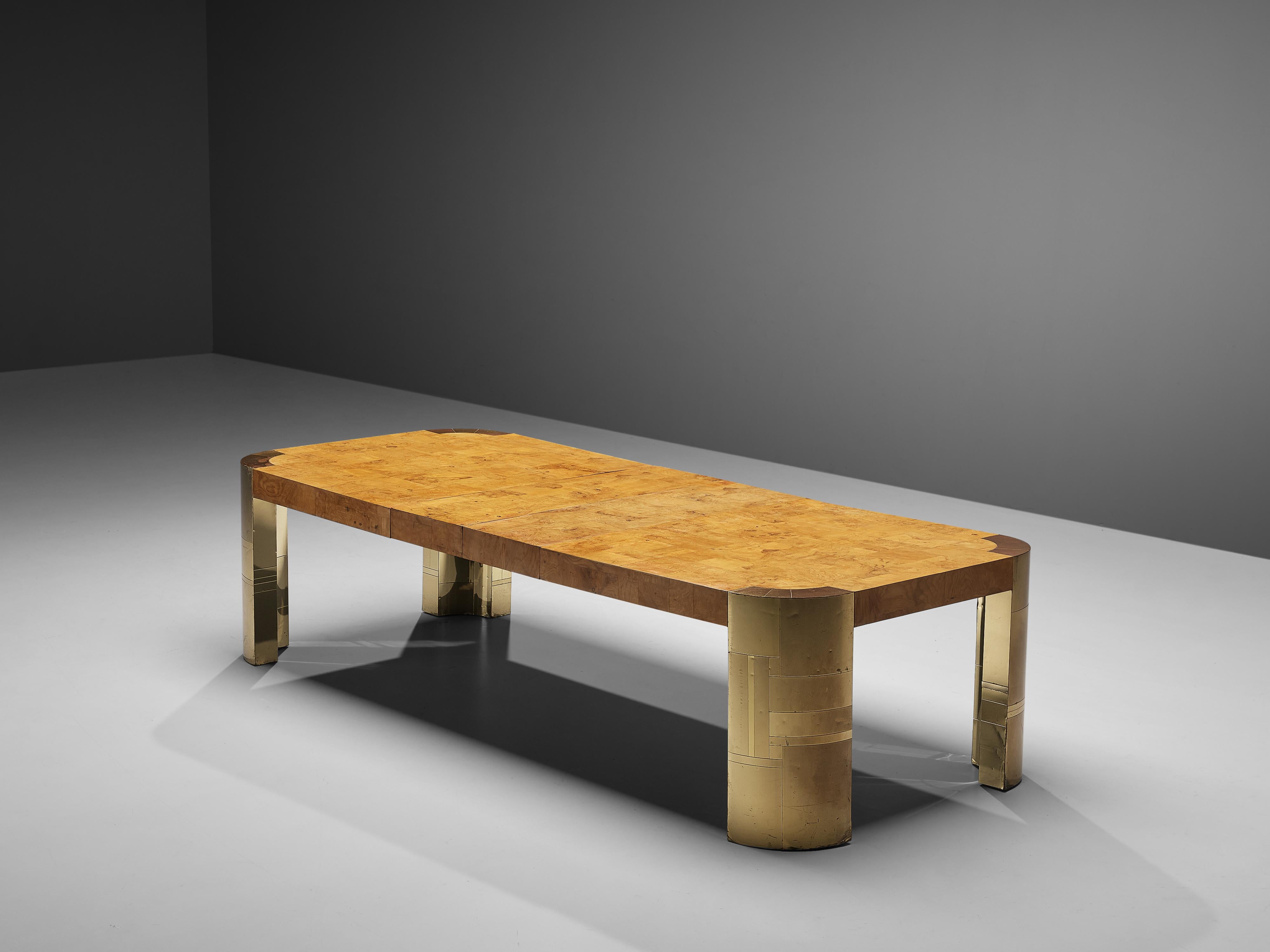 Paul Evans, extendable dining or conference table, wood burl, brass, United States, 1970s

Rare conference or large dining table by Paul Evans which comes with extension leaves. The long tabletop with rounded corners features an inlay of burl wood