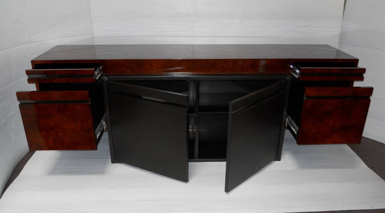 An amazing Paul Evans credenza or buffet. Made for Directional. Have four drawers and two center doors. Central section is covered in leather and has one interior shelf. Drawers have a strip of brushed steel for detail and float on either side of