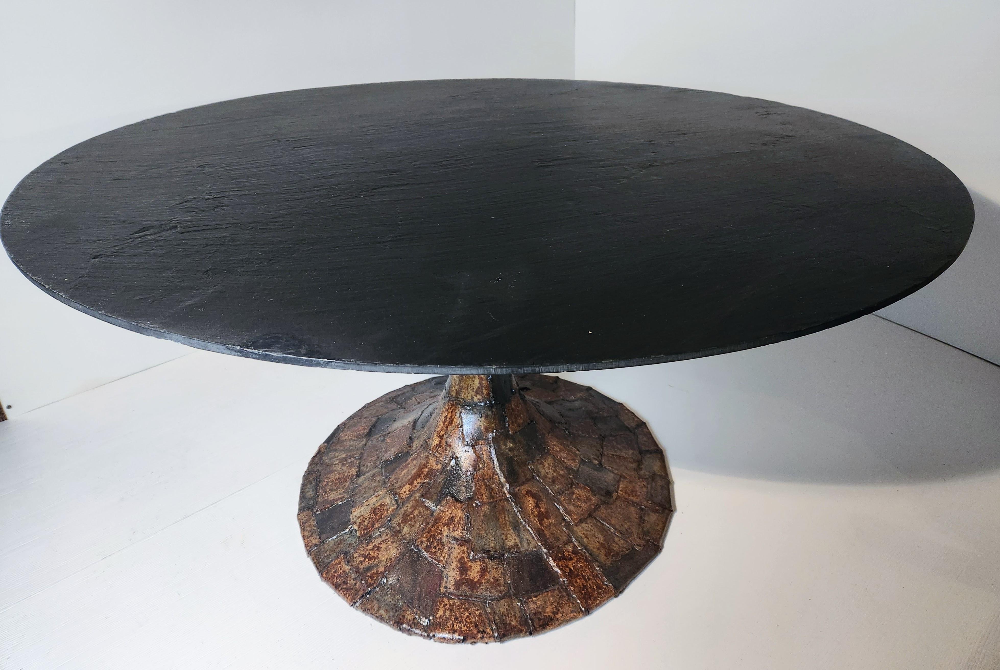 Early Paul Evans rare and wonderful dining table with three prong support atop of a welded enameled steel base composed of an overlaid welded steel patchwork of panels with an intriguing surface composition of which he and Dorsey Reading were