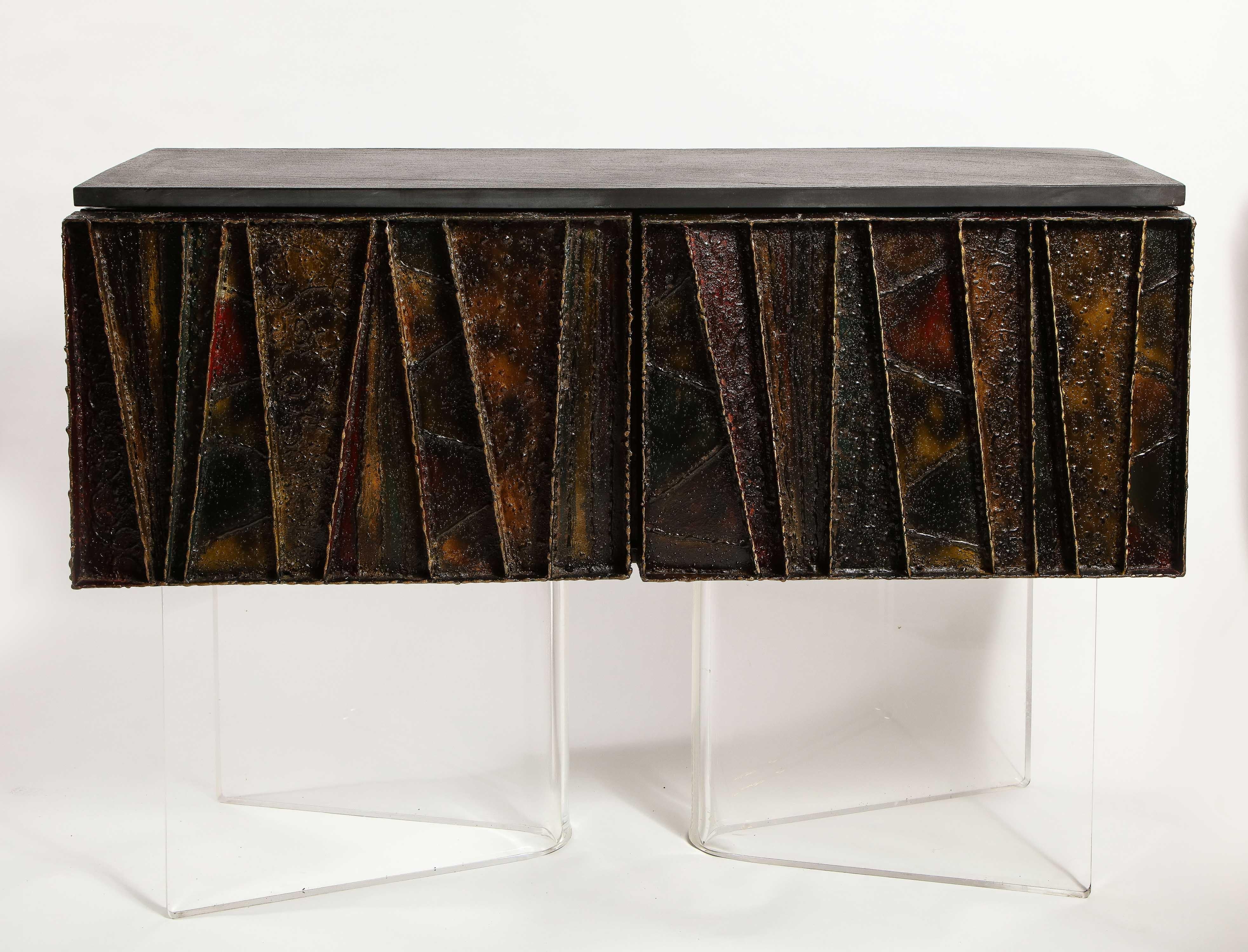 An exceptional Paul Evans signed and dated 1972 handcrafted “Deep Relief” Brutalist sideboard/cabinet made of brushed polychrome steel, slate, and wood. This a truly unique and modern angular form piece of furniture. Paul Evans is well known for his