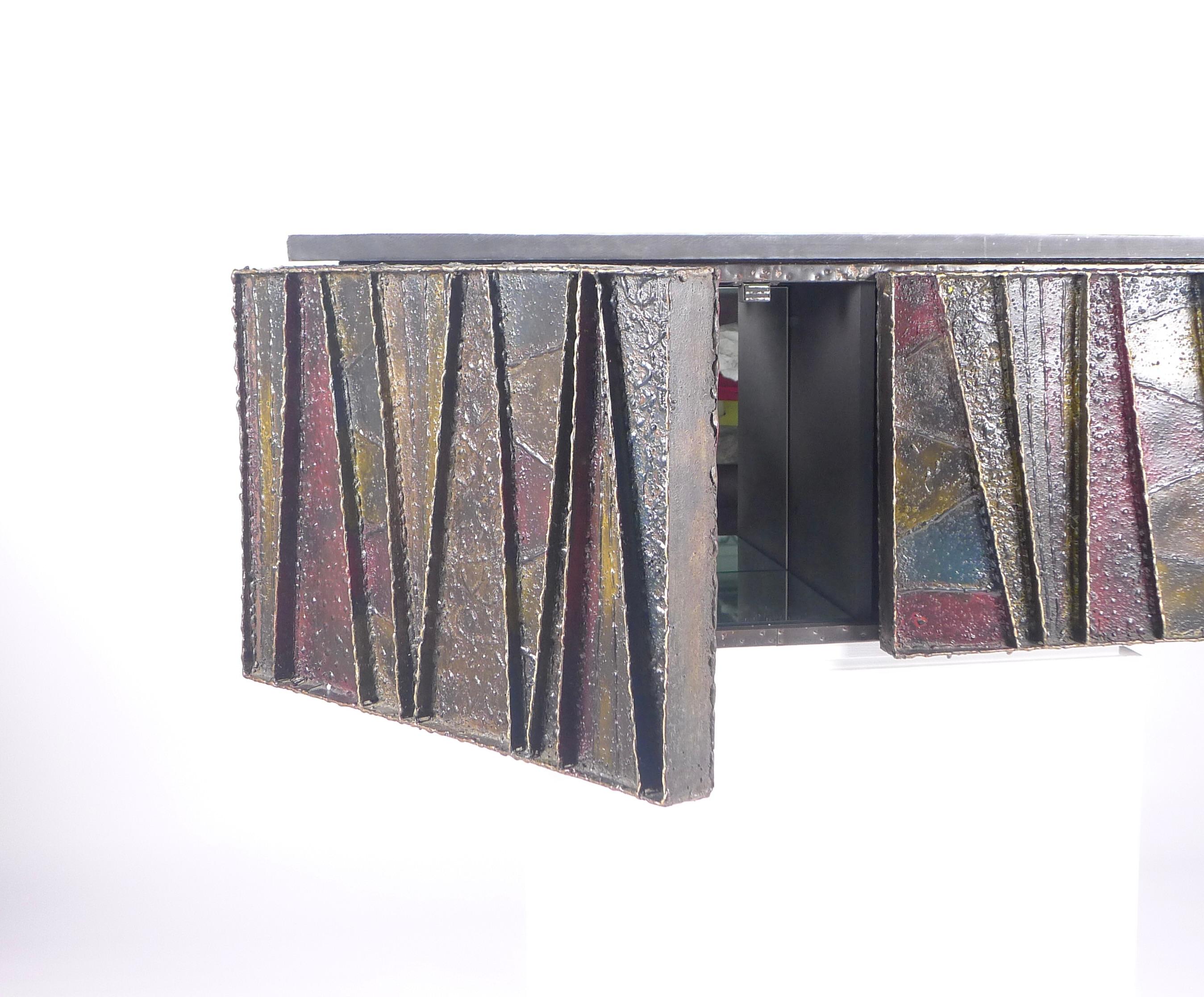 Paul Evans (1931-1987), 'Deep Relief' wall-mounted cabinet, model PE-19

Made by Paul Evans Studio, New Hope, Pennsylvania for Directional Furniture Company, New York.

Patinated steel and bronze exterior in the Brutalist style, painted in gold,