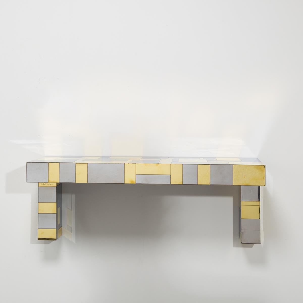 Paul Evans designed brass and chrome-plated steel wall hung console table or shelf for Directional's 'Cityscape Series' circa 1975 signed. 

Paul Evans was born in Pennsylvania in 1931. He studied sculpture, metal work and silver and gold