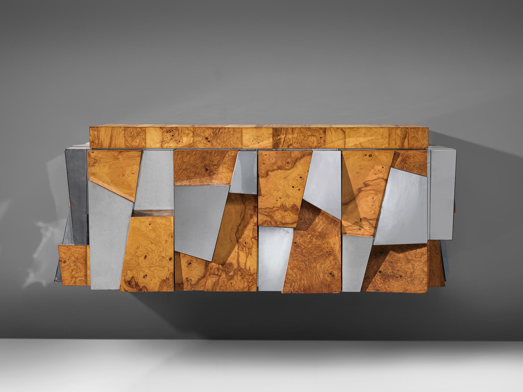 Paul Evans for Directional, 'Faceted' wall-mounted cabinet, chromed steel, olive burl, glass, United States, 1970s

A beautiful wall-mounted sideboard by Paul Evans for Directional. The piece is an excellent example of how Evans’ Cityscape series